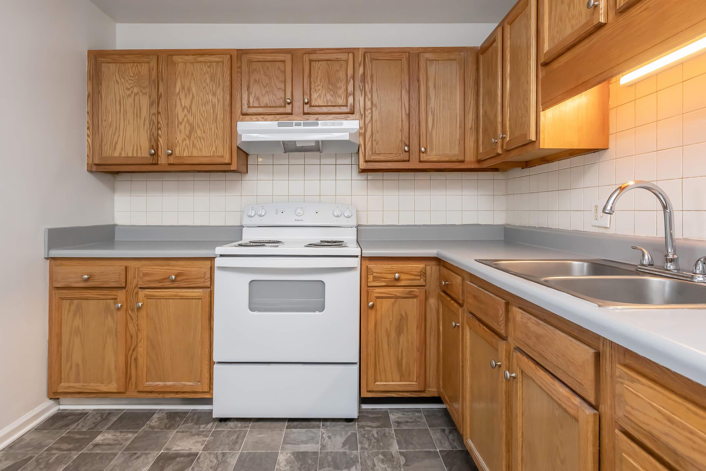 a kitchen with stainless steel appliances and wooden cabinets