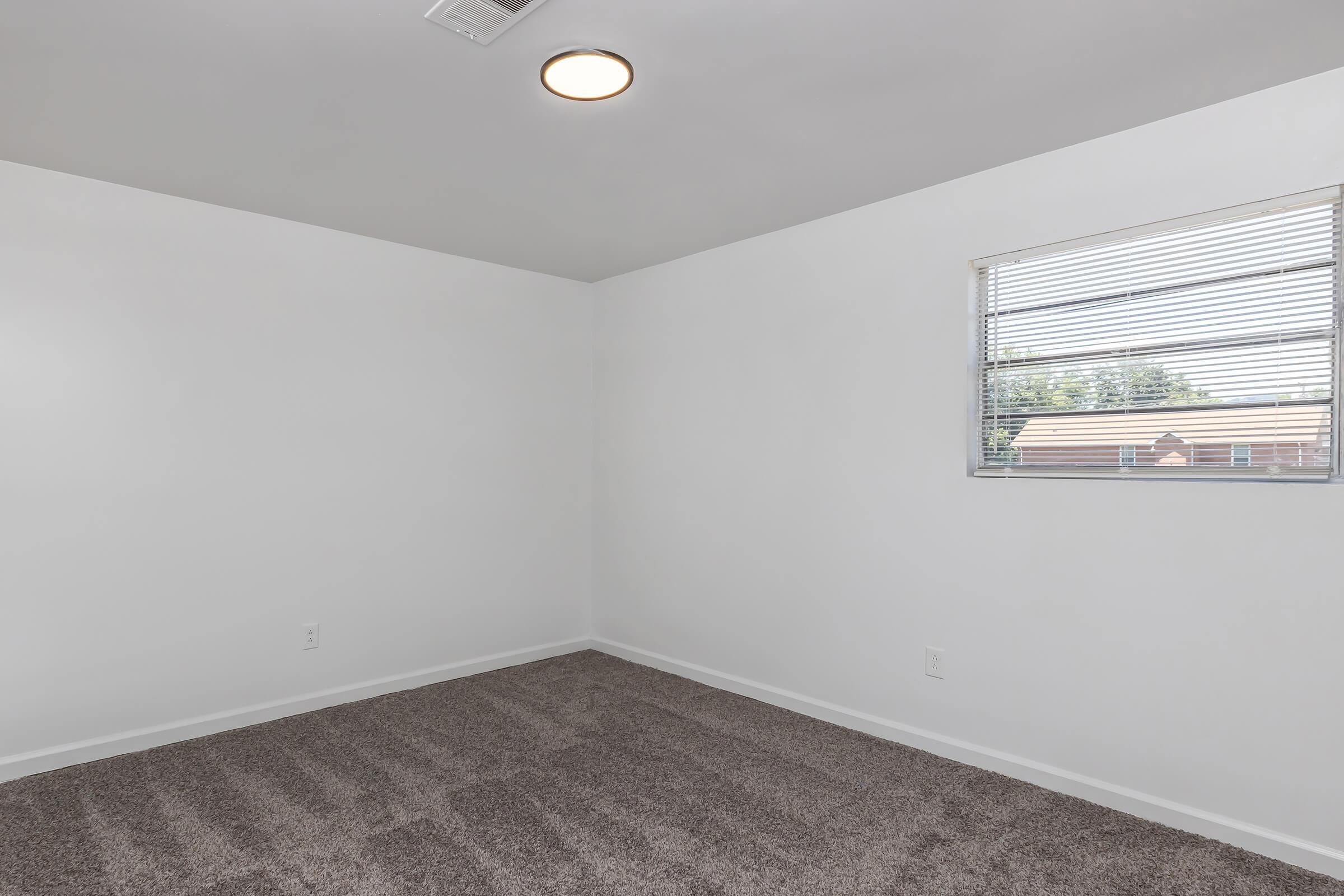 a bedroom with a large window