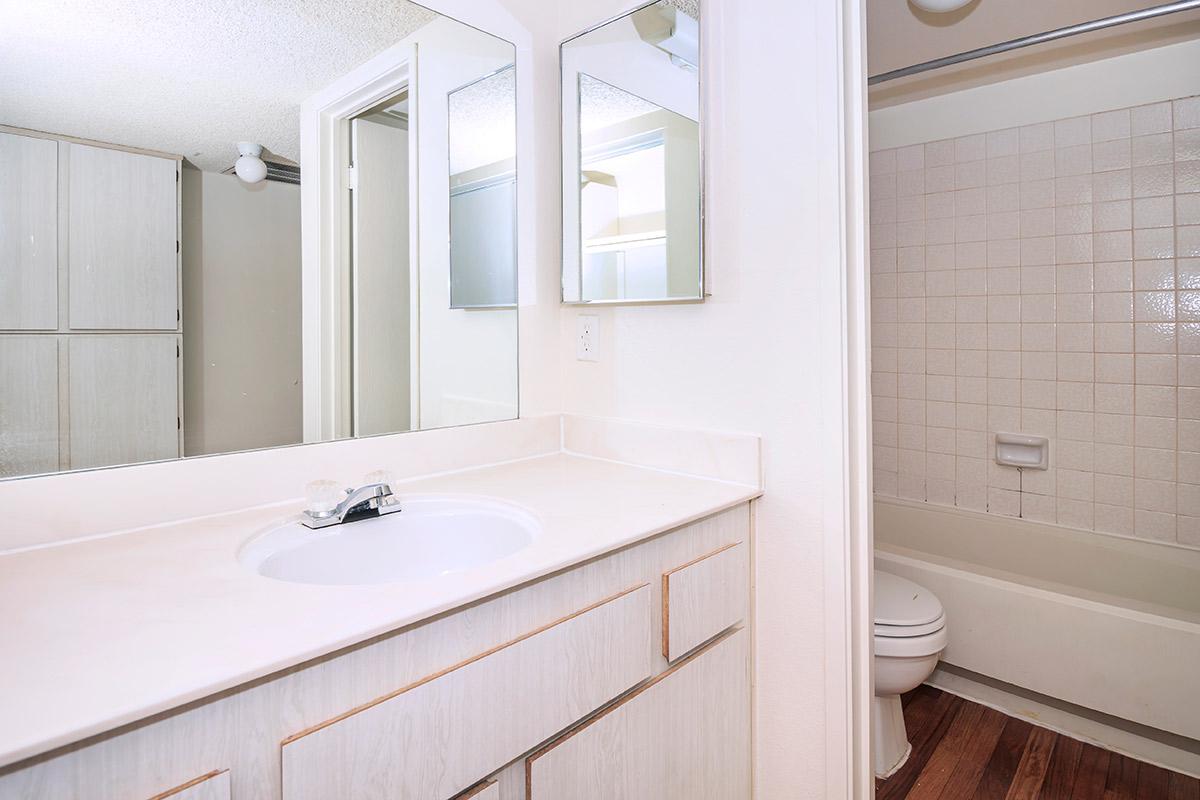 a white sink sitting under a window