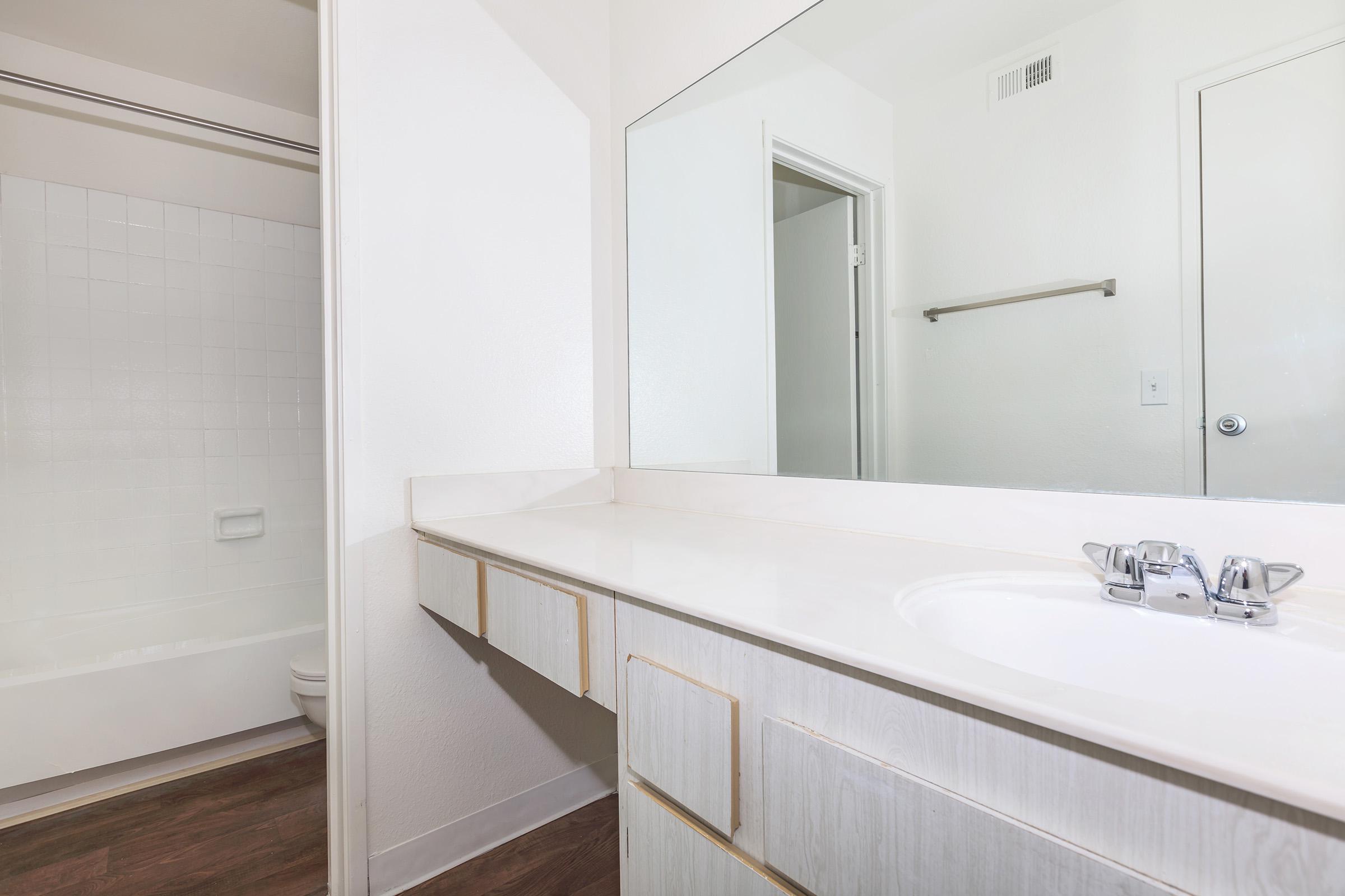a room with a sink and a mirror
