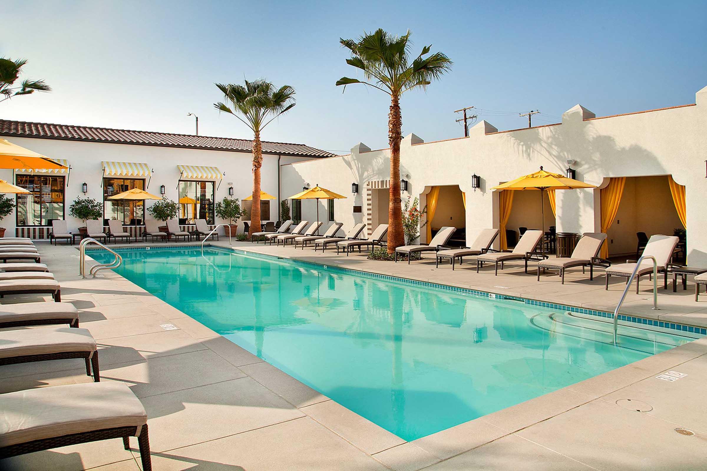 a pool with lounge chairs