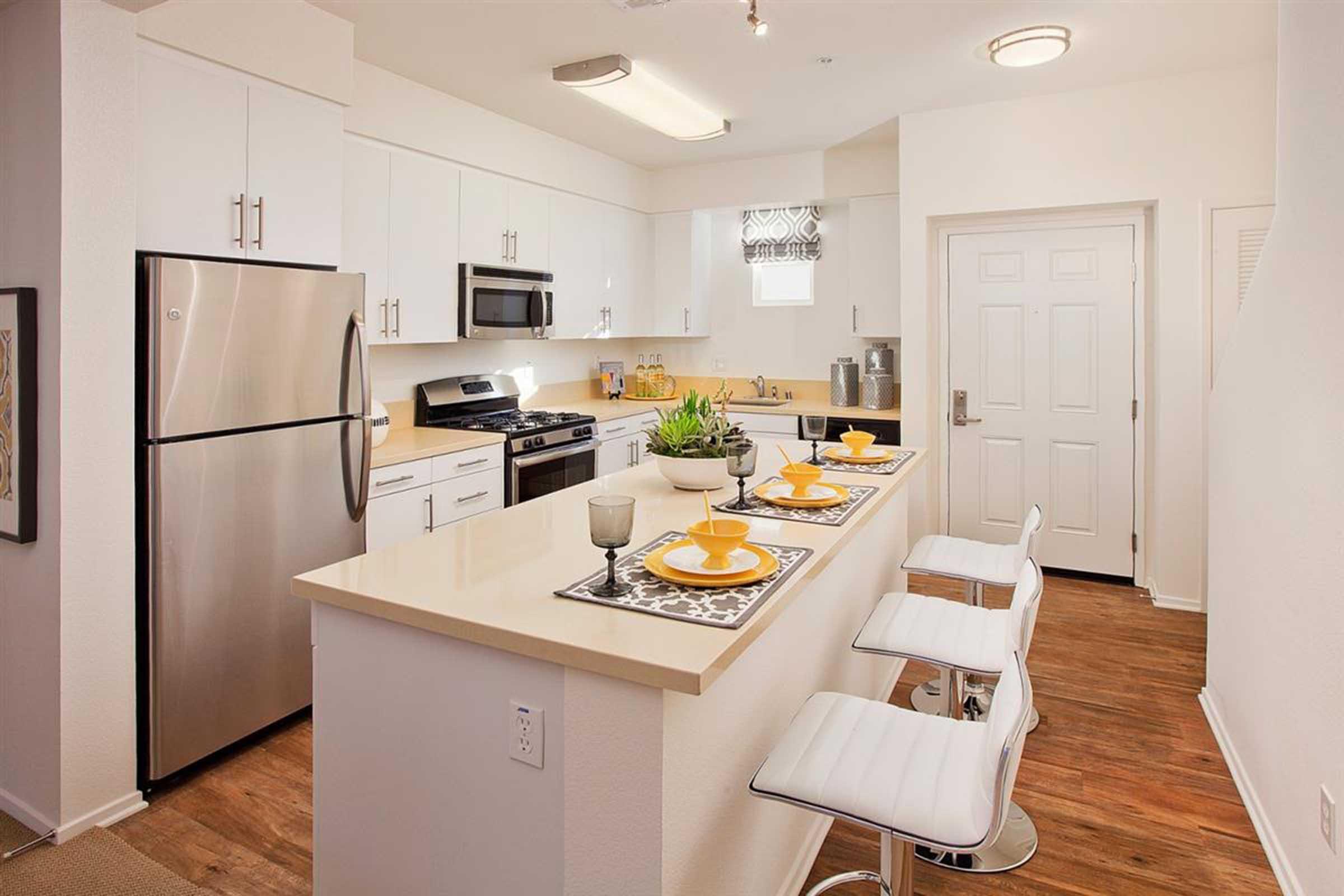 a kitchen with a sink and a refrigerator