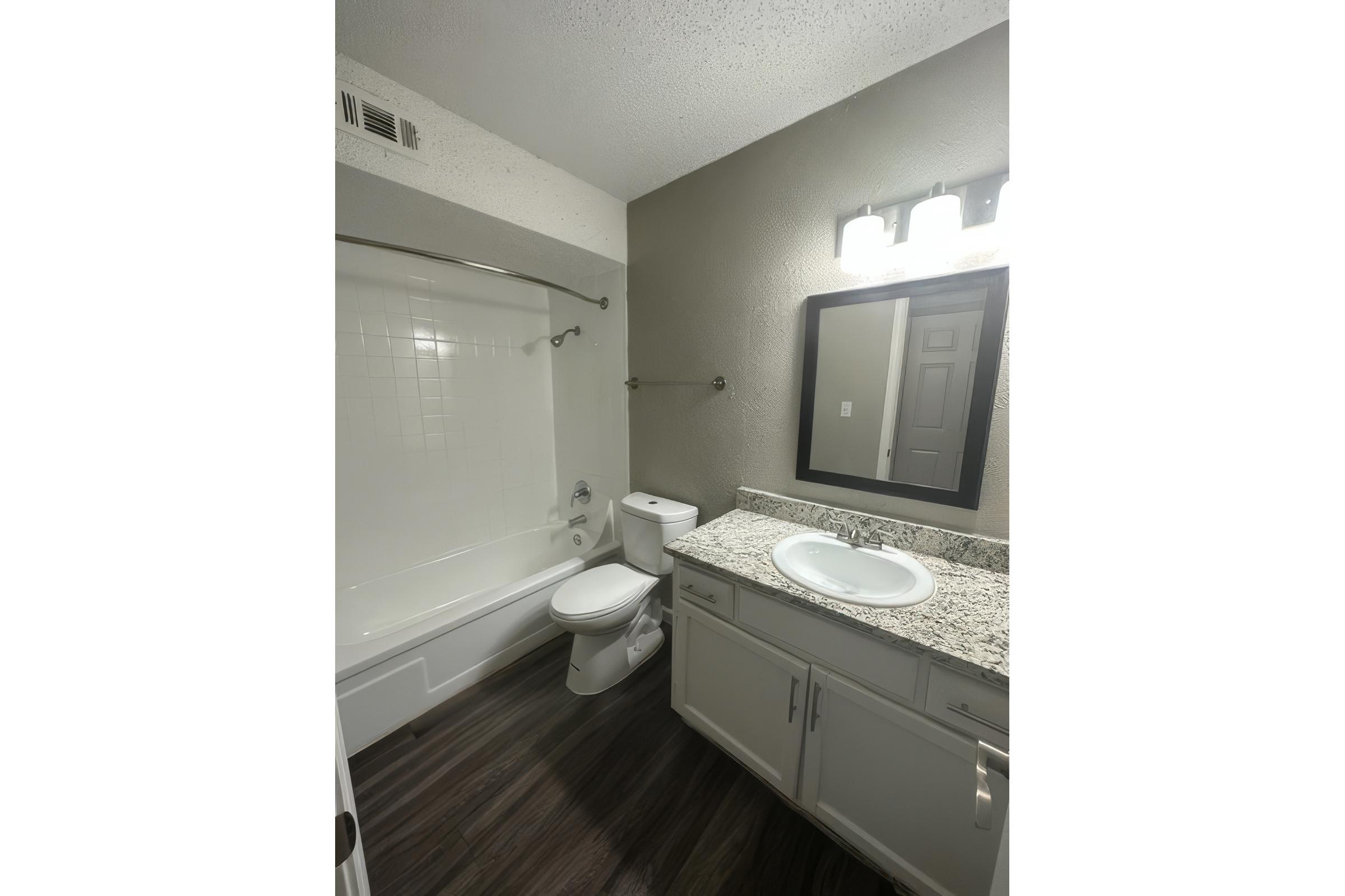 a kitchen with a sink and a mirror