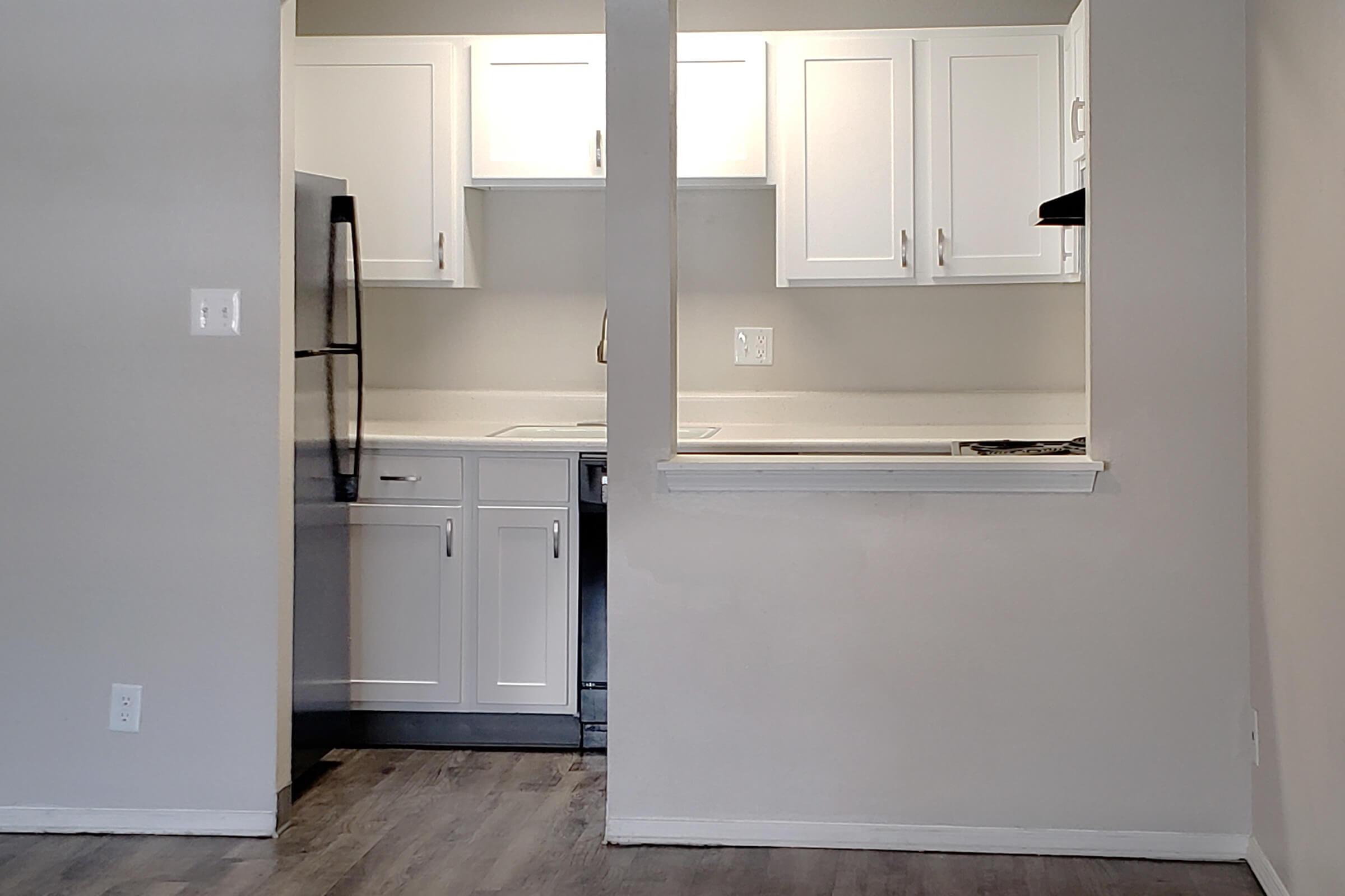 a kitchen with a sink and a refrigerator