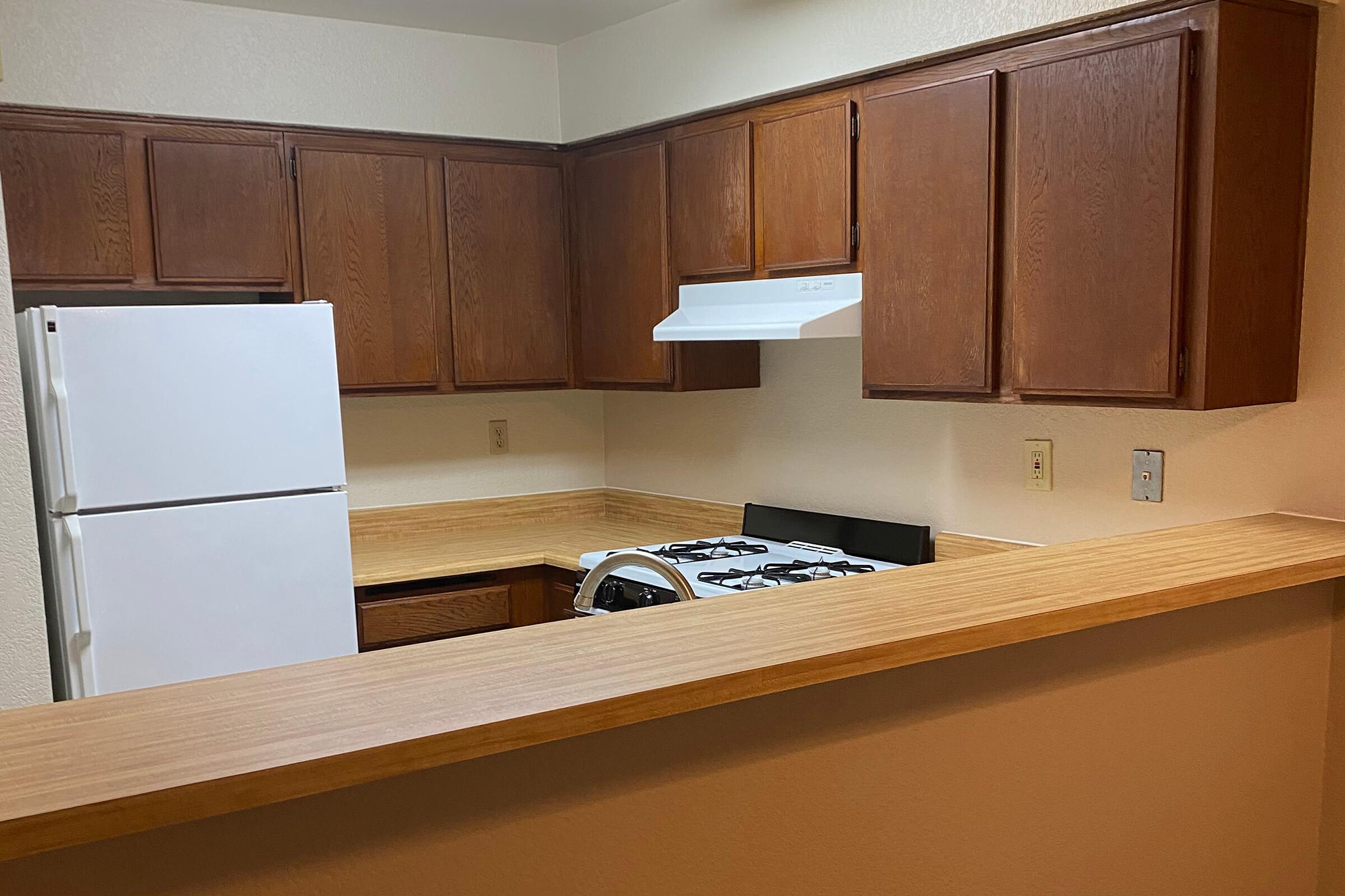 a kitchen with a sink and a refrigerator