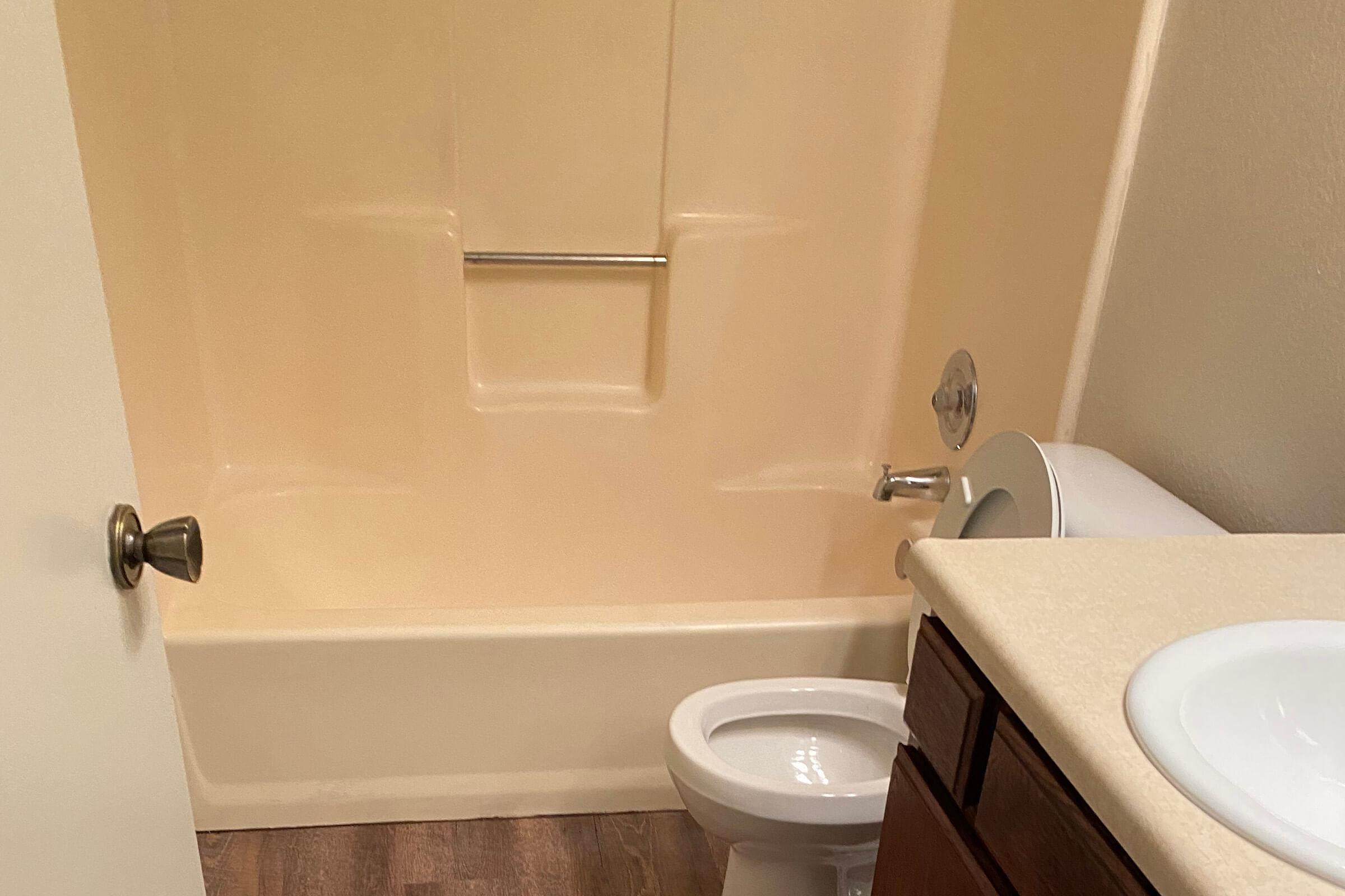 a white tub sitting next to a sink