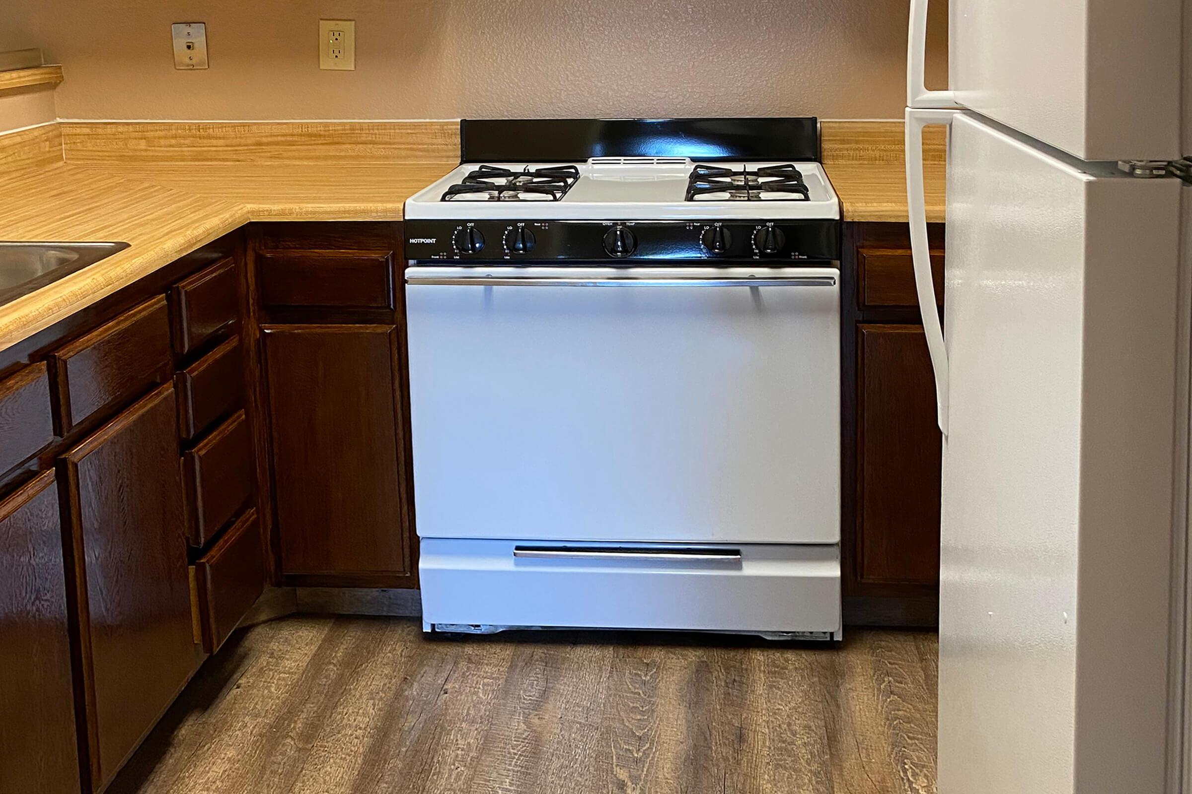 a stove top oven sitting inside of a kitchen