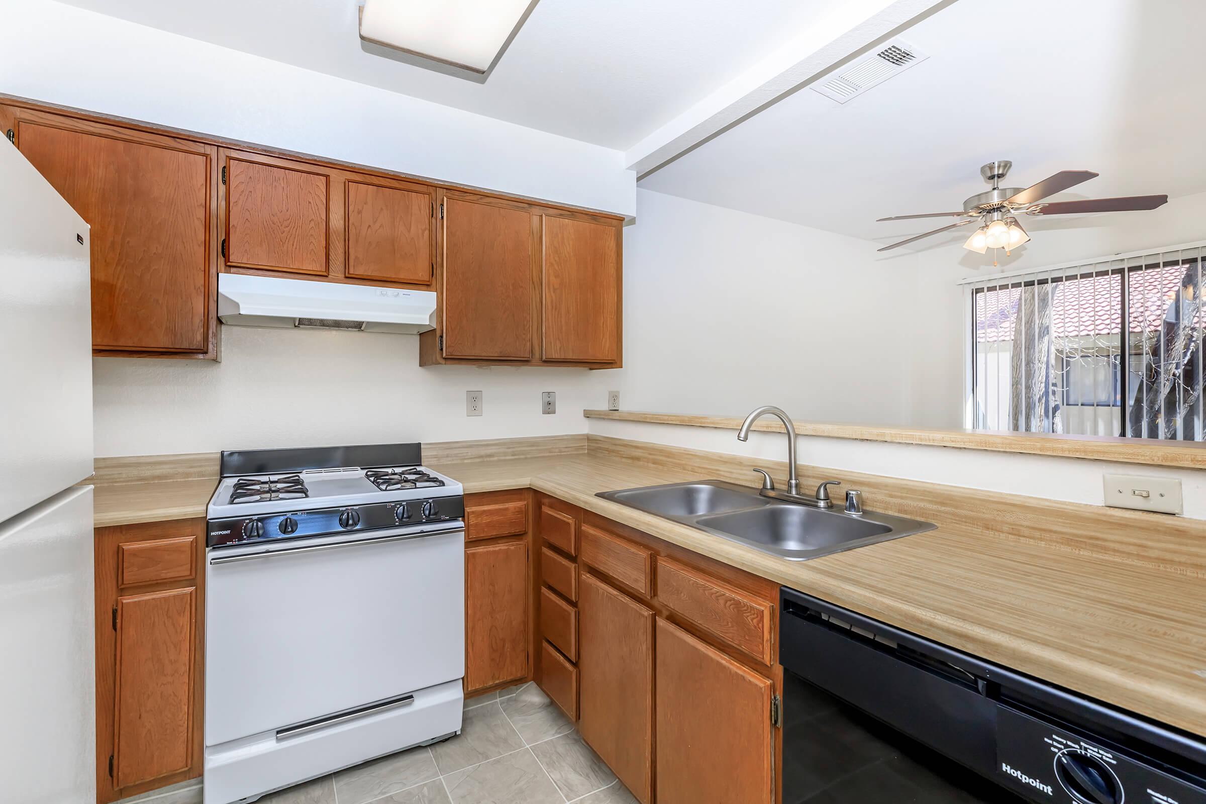 a kitchen with stainless steel appliances and wooden cabinets