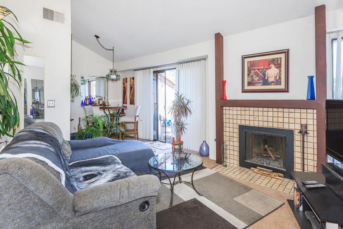 a living room filled with furniture and a fire place