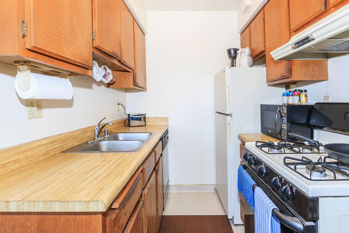 a stove top oven sitting inside of a kitchen