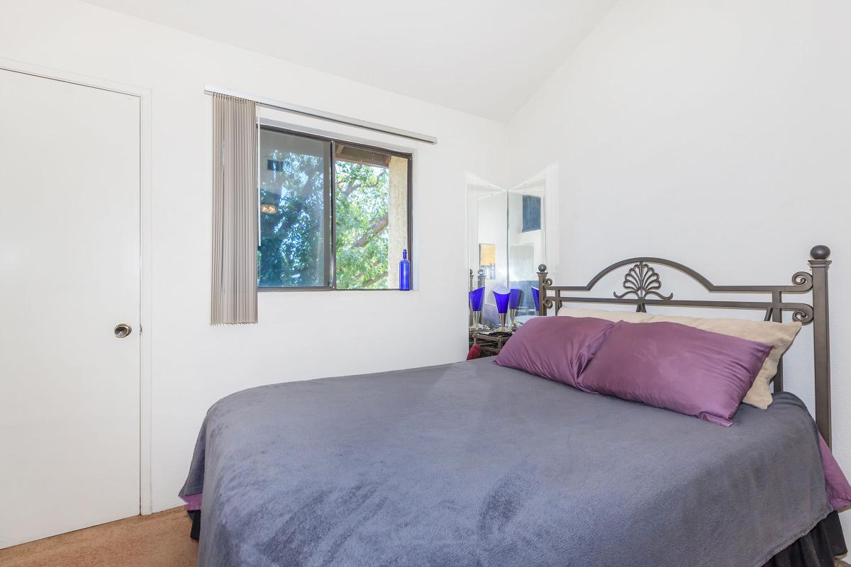 a bedroom with a large bed sitting in a room