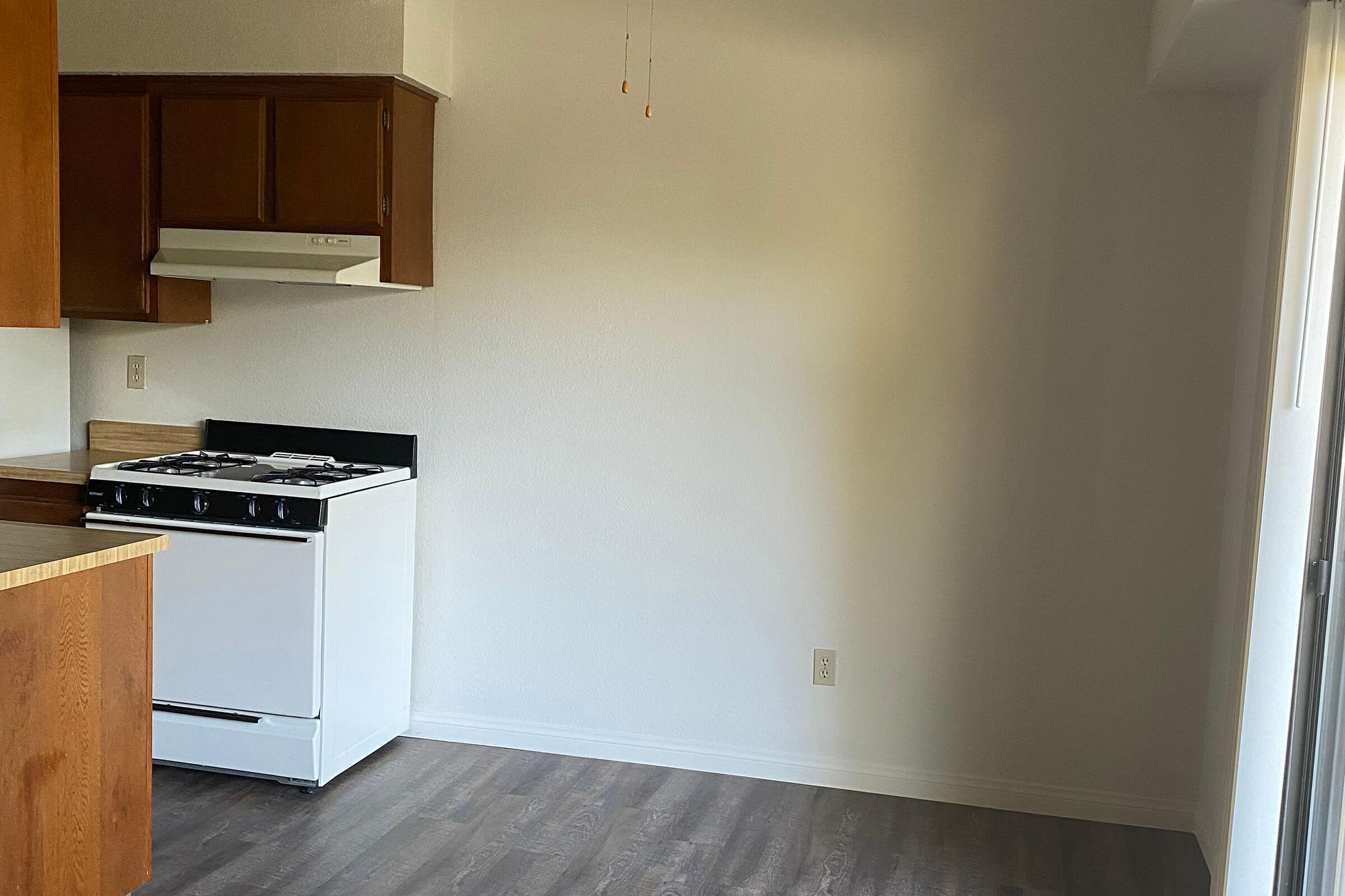 a kitchen with a stove and a refrigerator