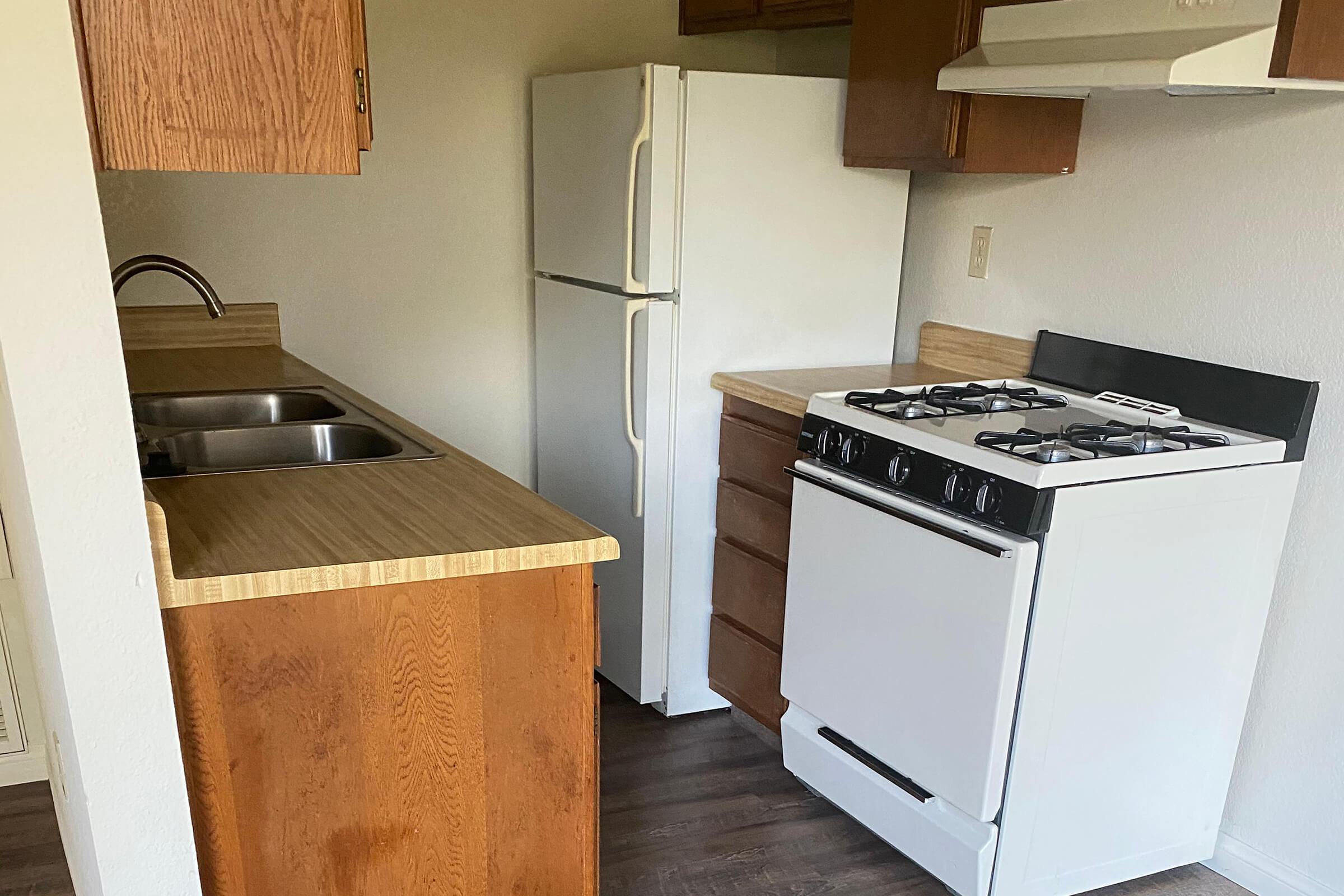 a stove top oven sitting inside of a kitchen