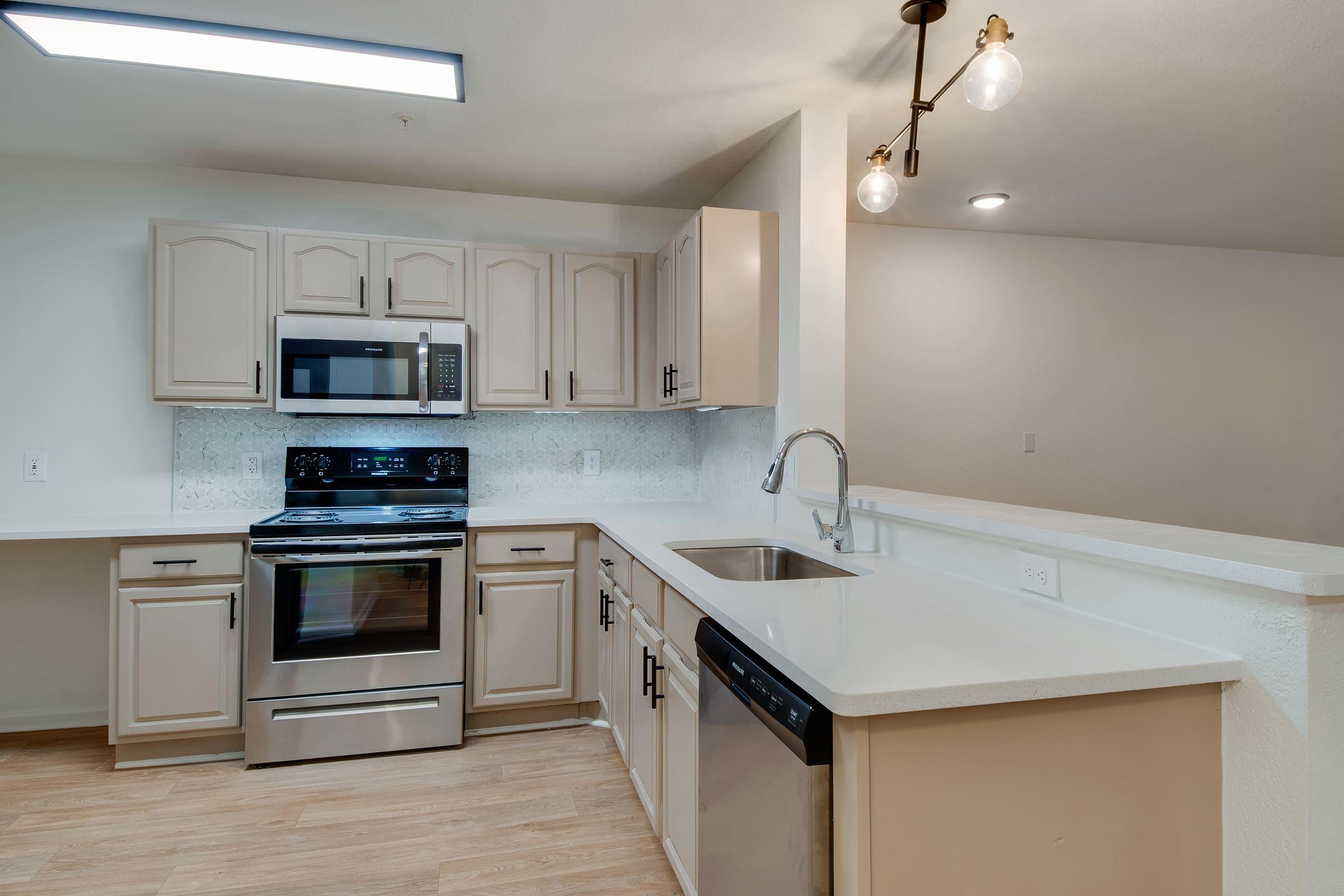 a kitchen with a sink and a microwave