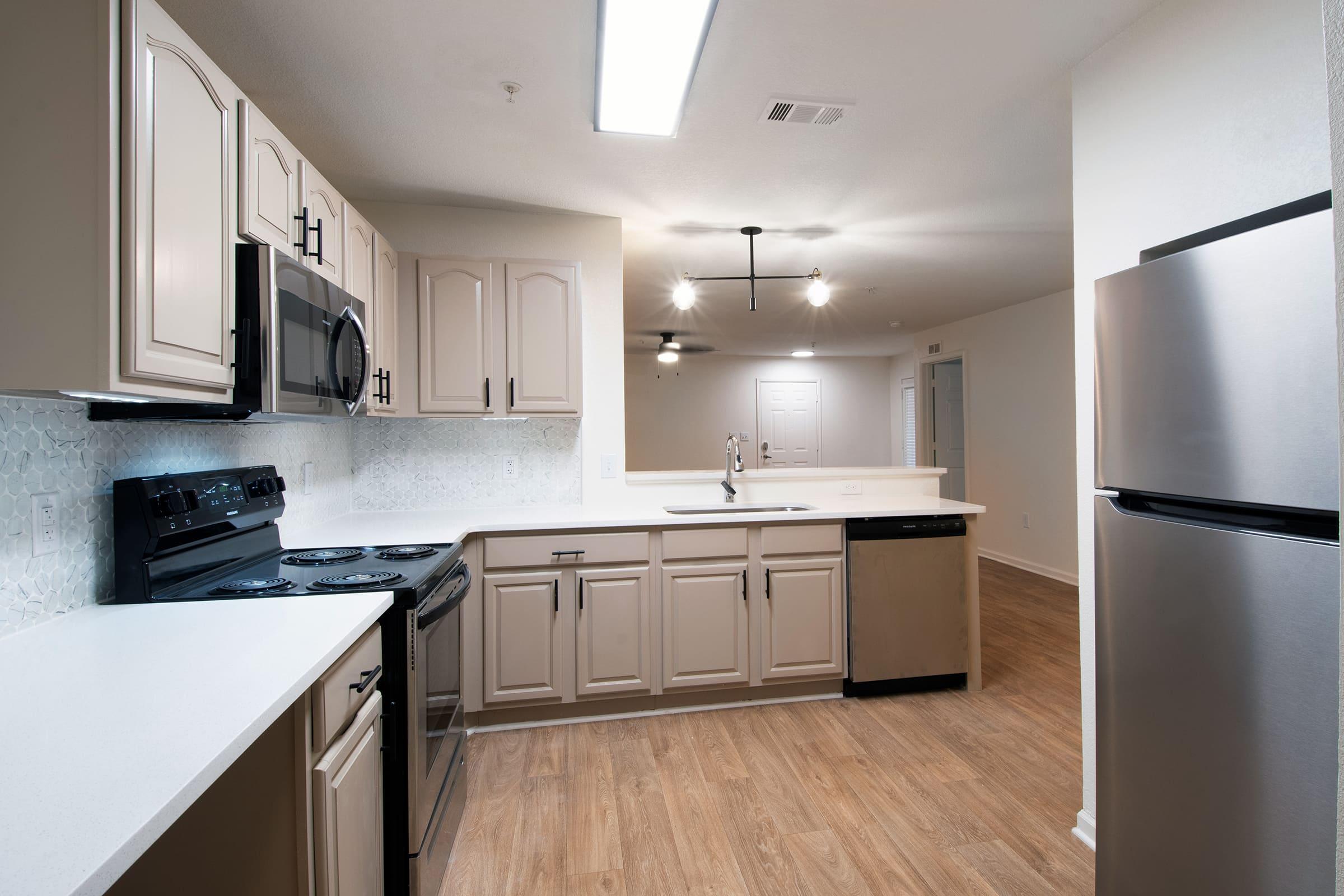 a kitchen with a sink and a refrigerator