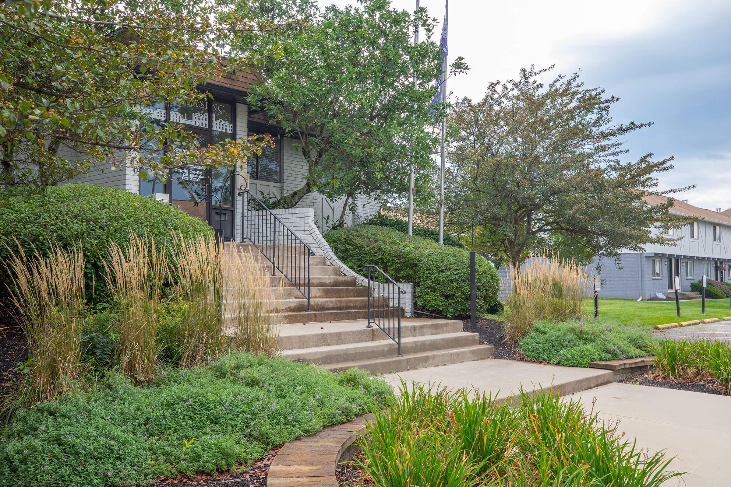 a path with trees on the side of a building