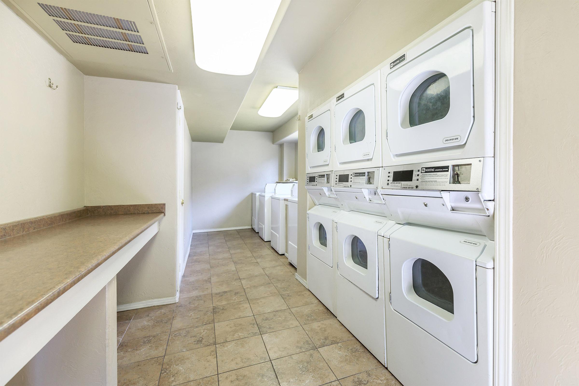 a white microwave oven sitting on top of a refrigerator