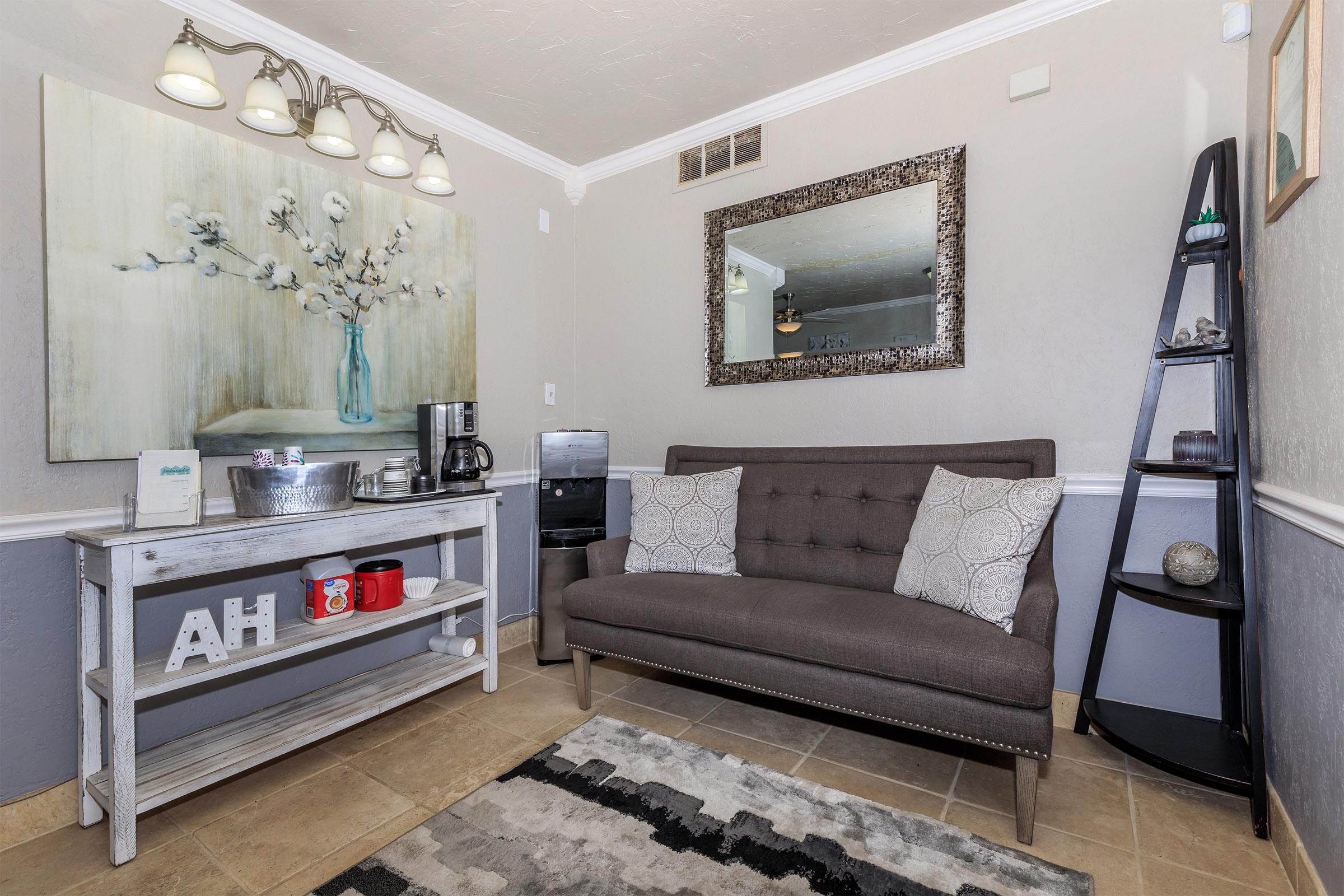 a living room with a sink and a mirror