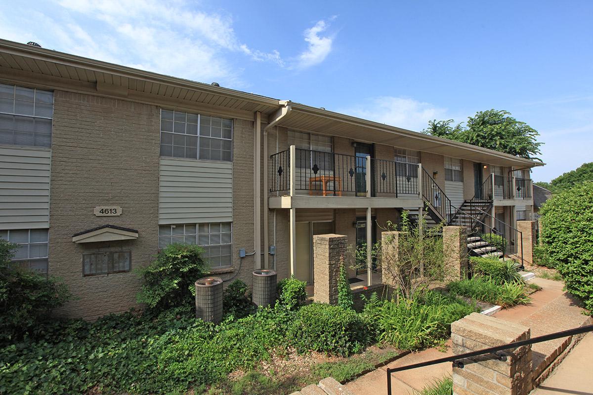 a house with bushes in front of a building