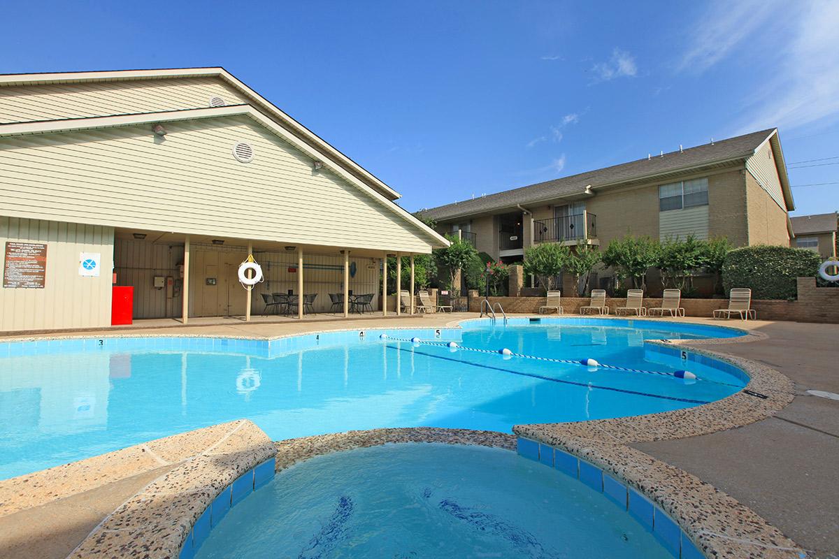 a house with a pool in front of a building