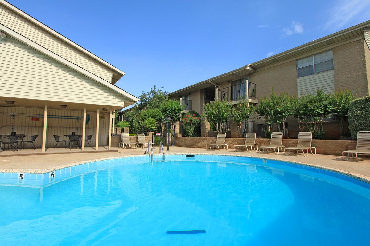 a house with a pool in front of a building