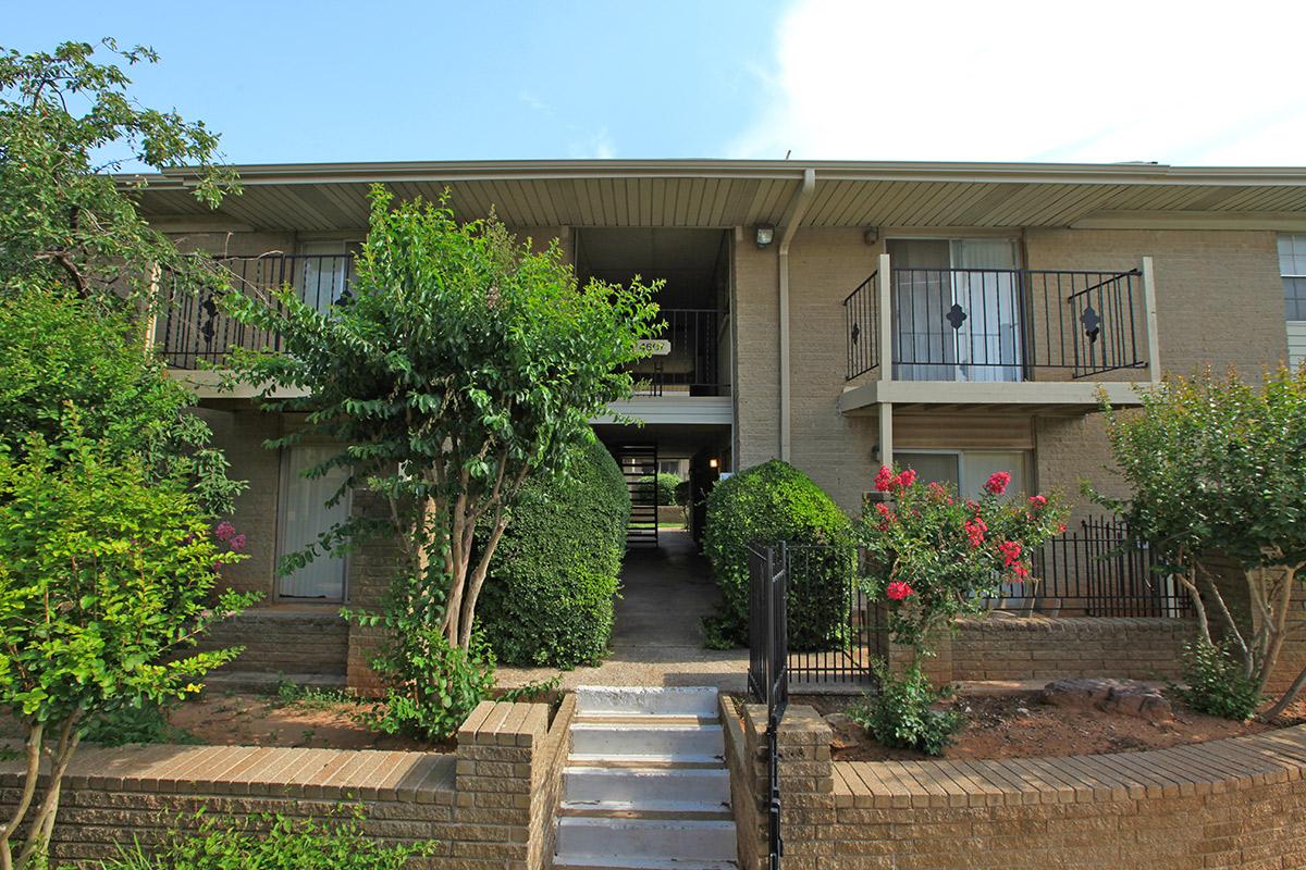 a house with bushes in front of a building