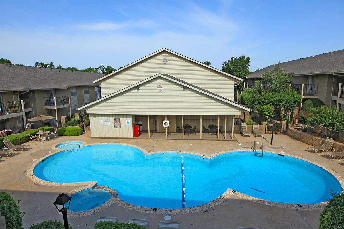 a house with a pool in front of a building