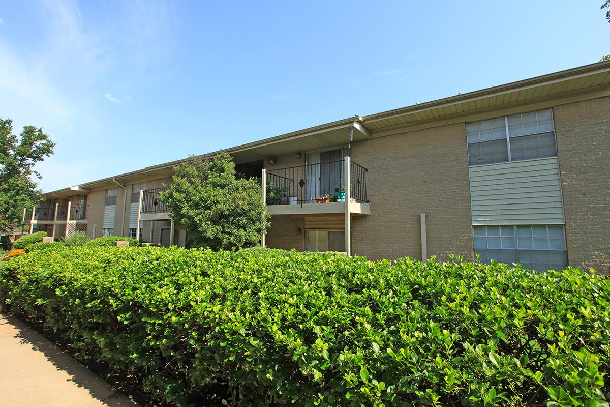 a house with bushes in front of a building