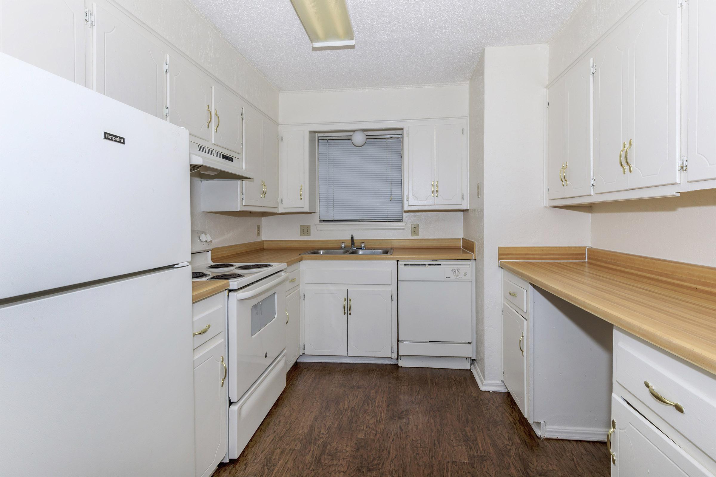 a white refrigerator freezer sitting inside of a kitchen