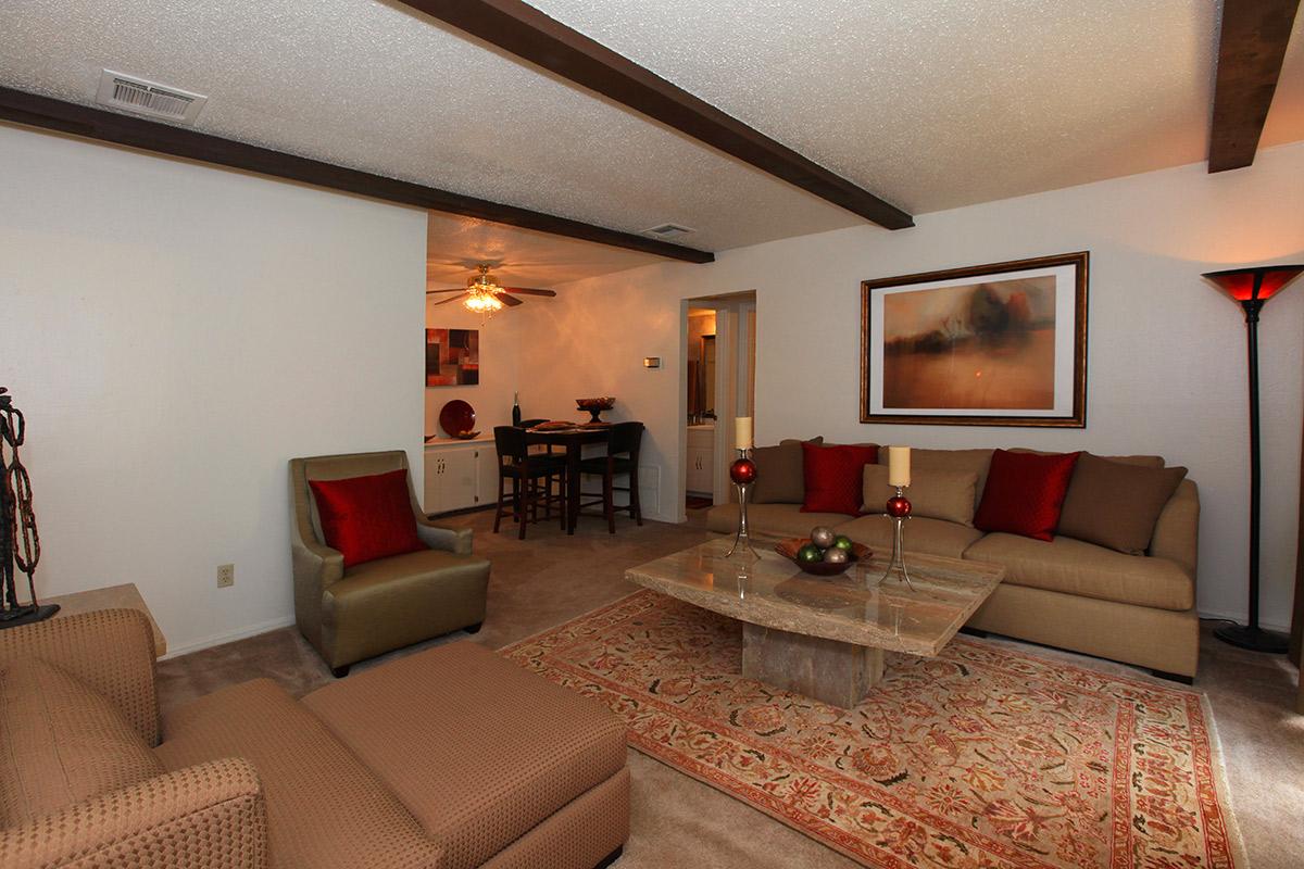 a living room filled with furniture and a flat screen tv