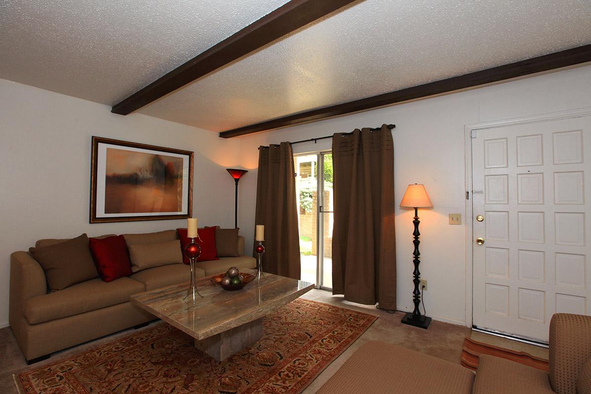 a living room filled with furniture and a flat screen tv