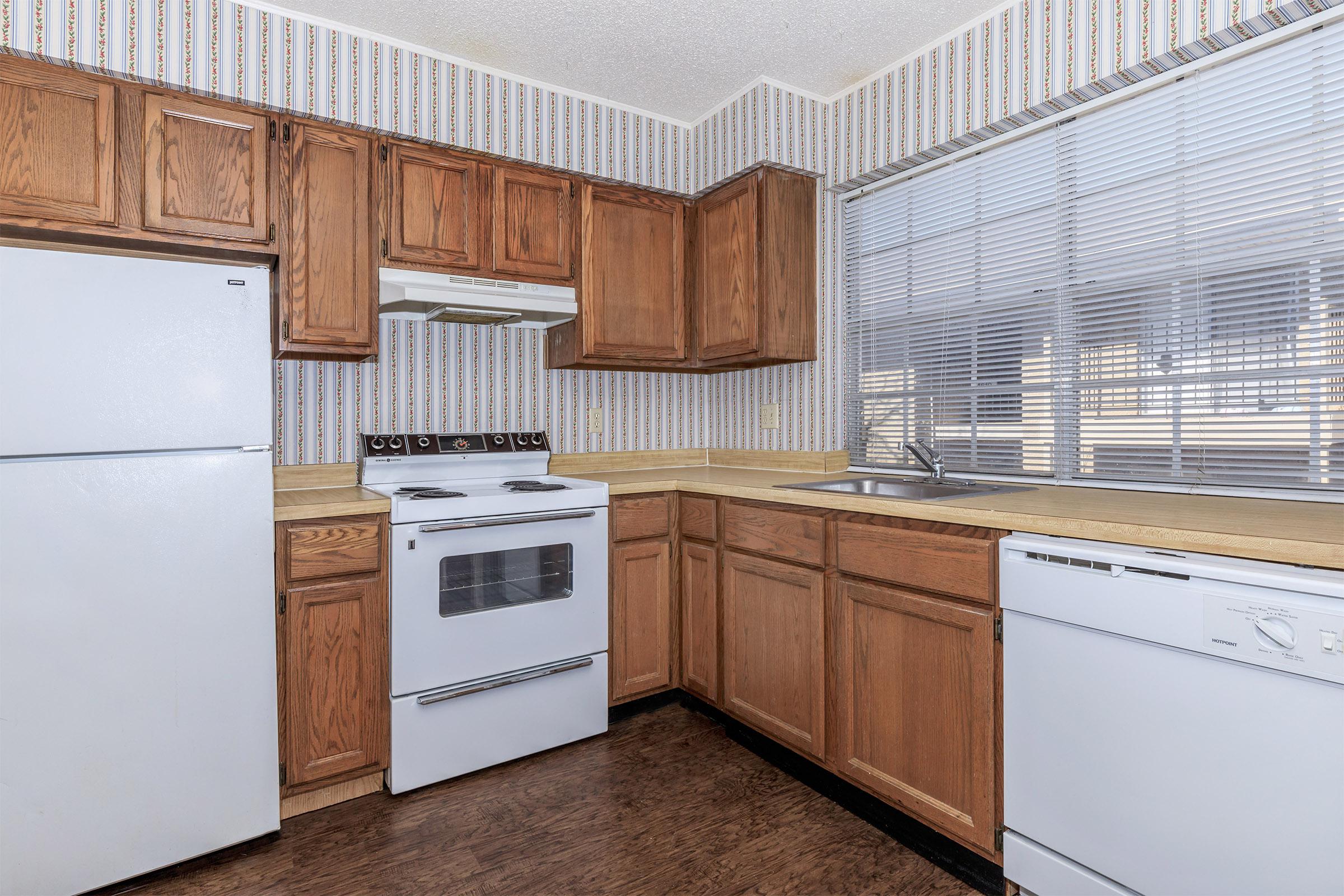 a kitchen with a stove and a refrigerator