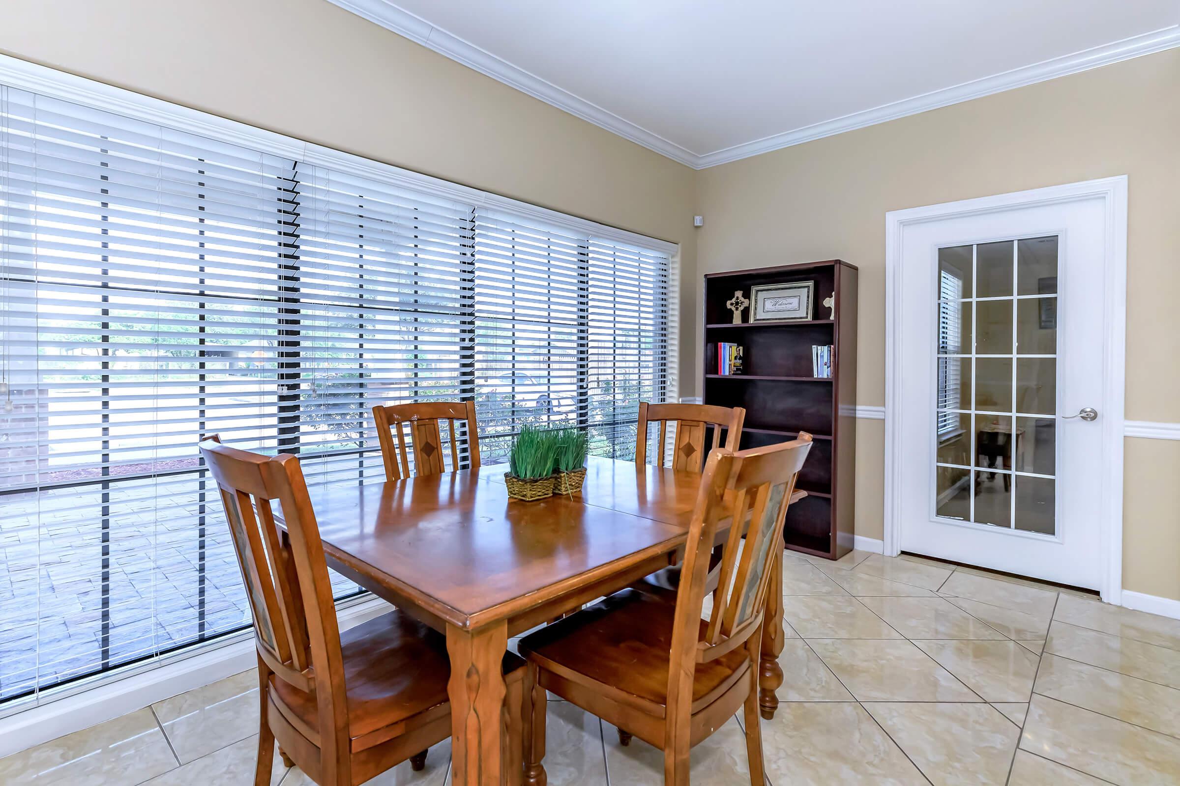 a dining room table in front of a window