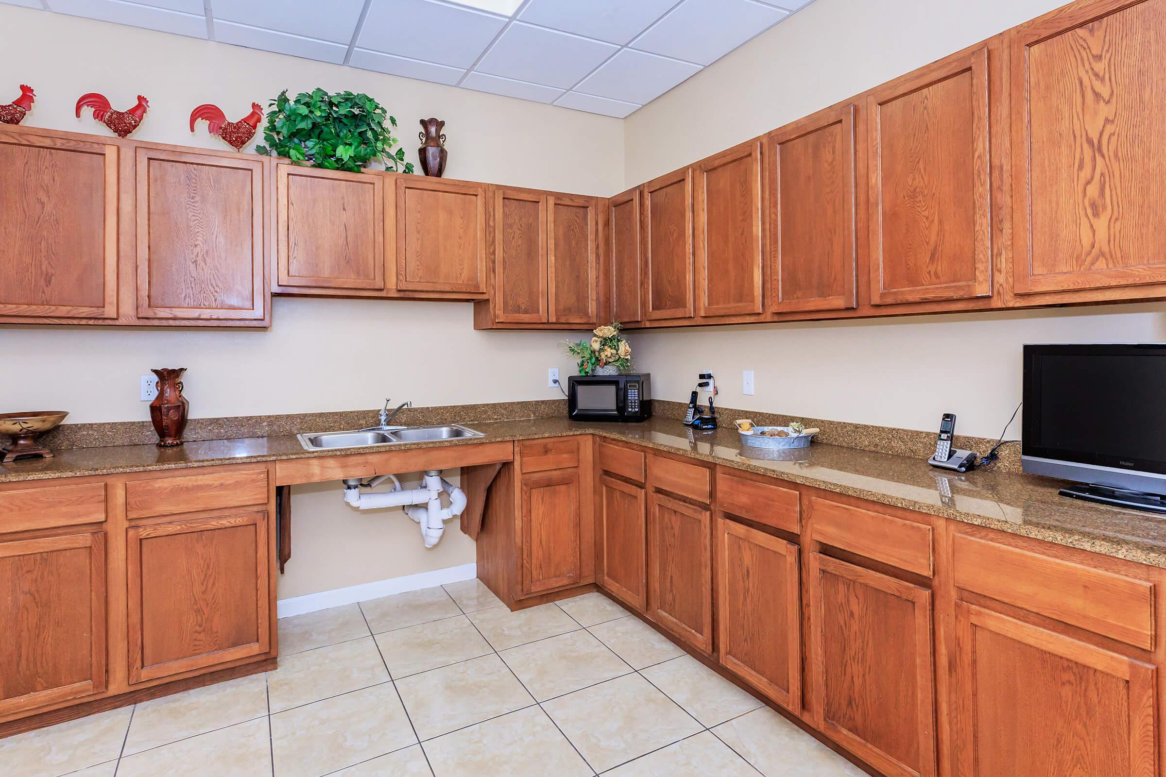 a large kitchen with stainless steel appliances and wooden cabinets