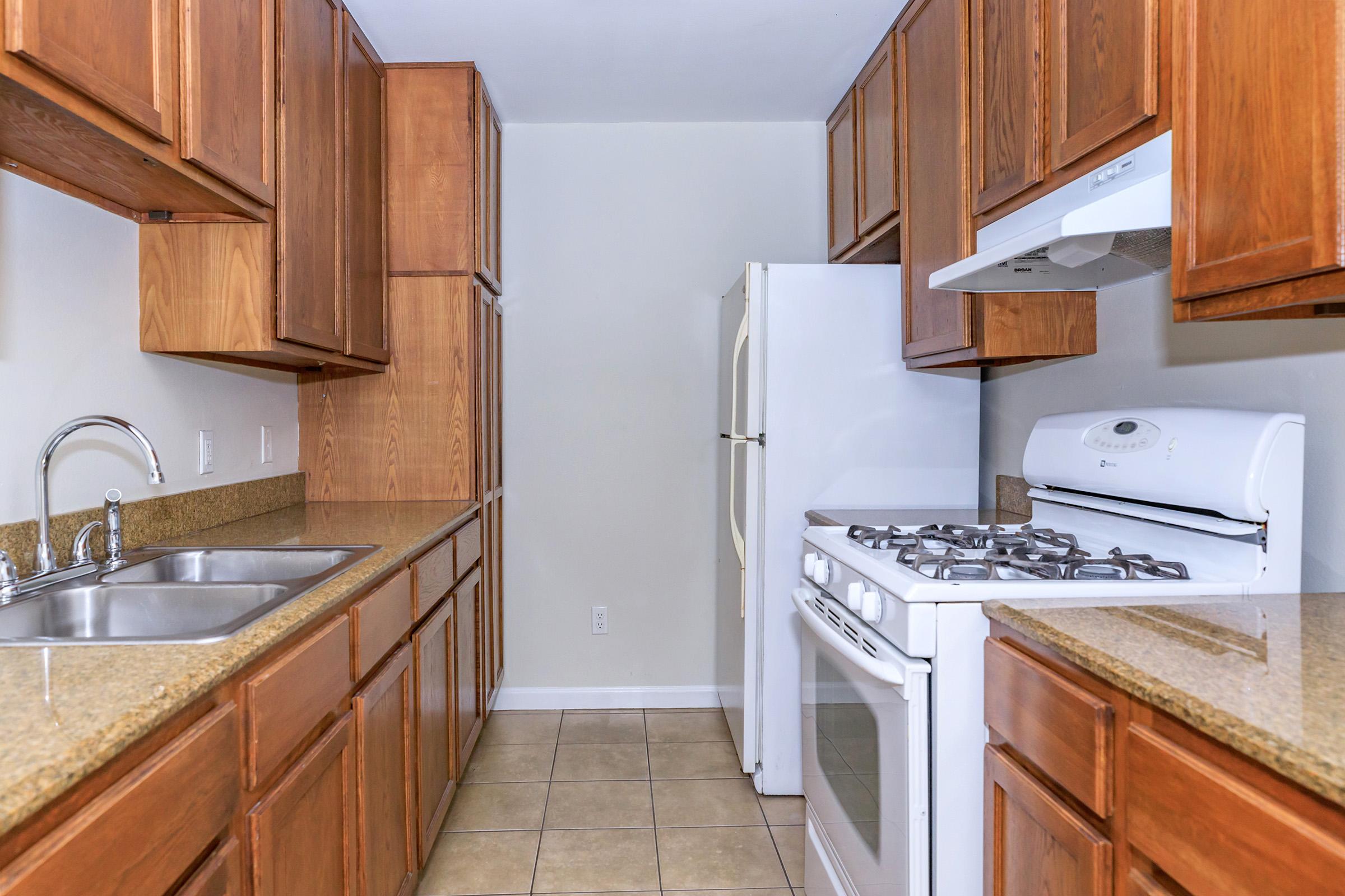 a kitchen with stainless steel appliances and wooden cabinets