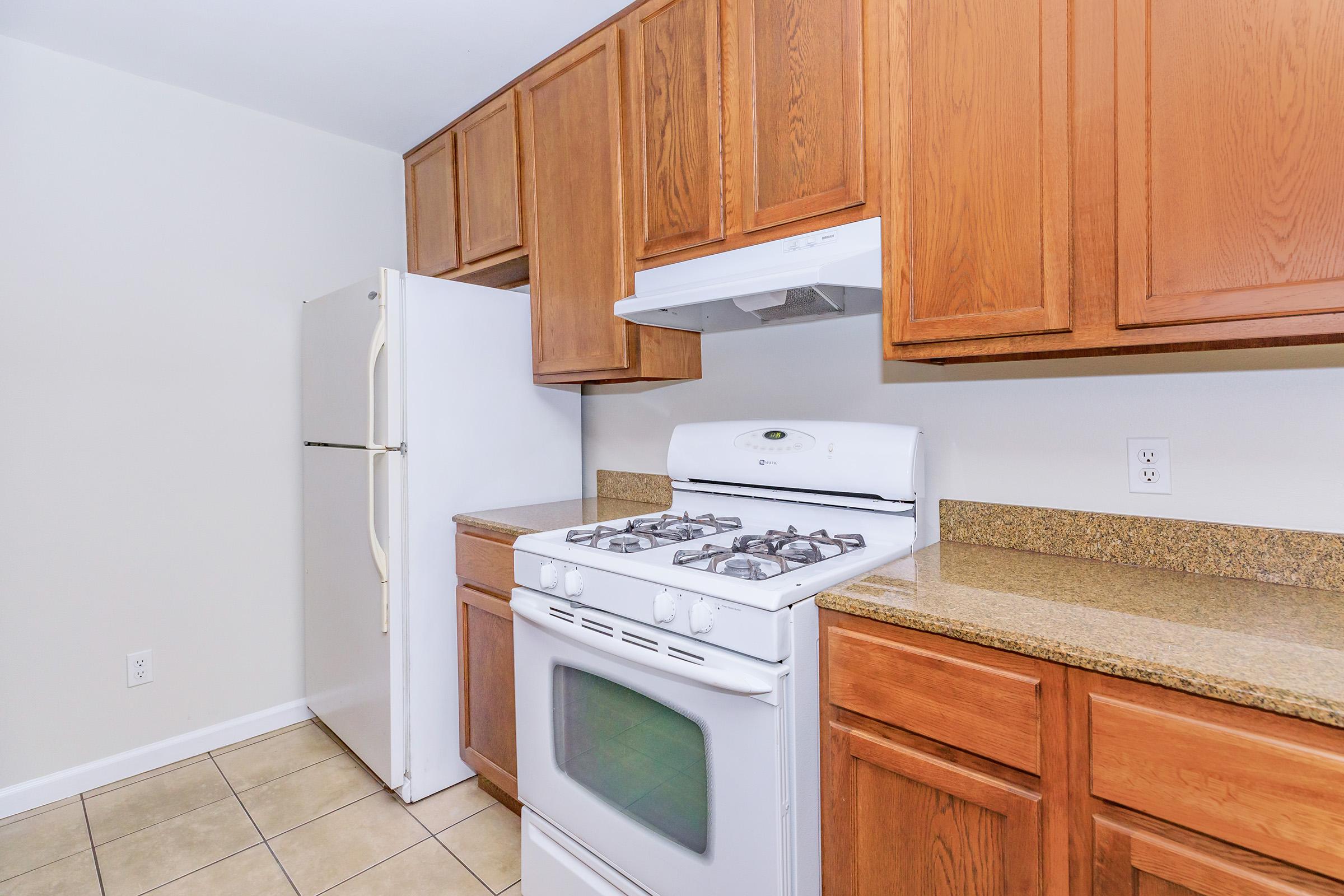 a kitchen with a stove top oven sitting inside of a refrigerator