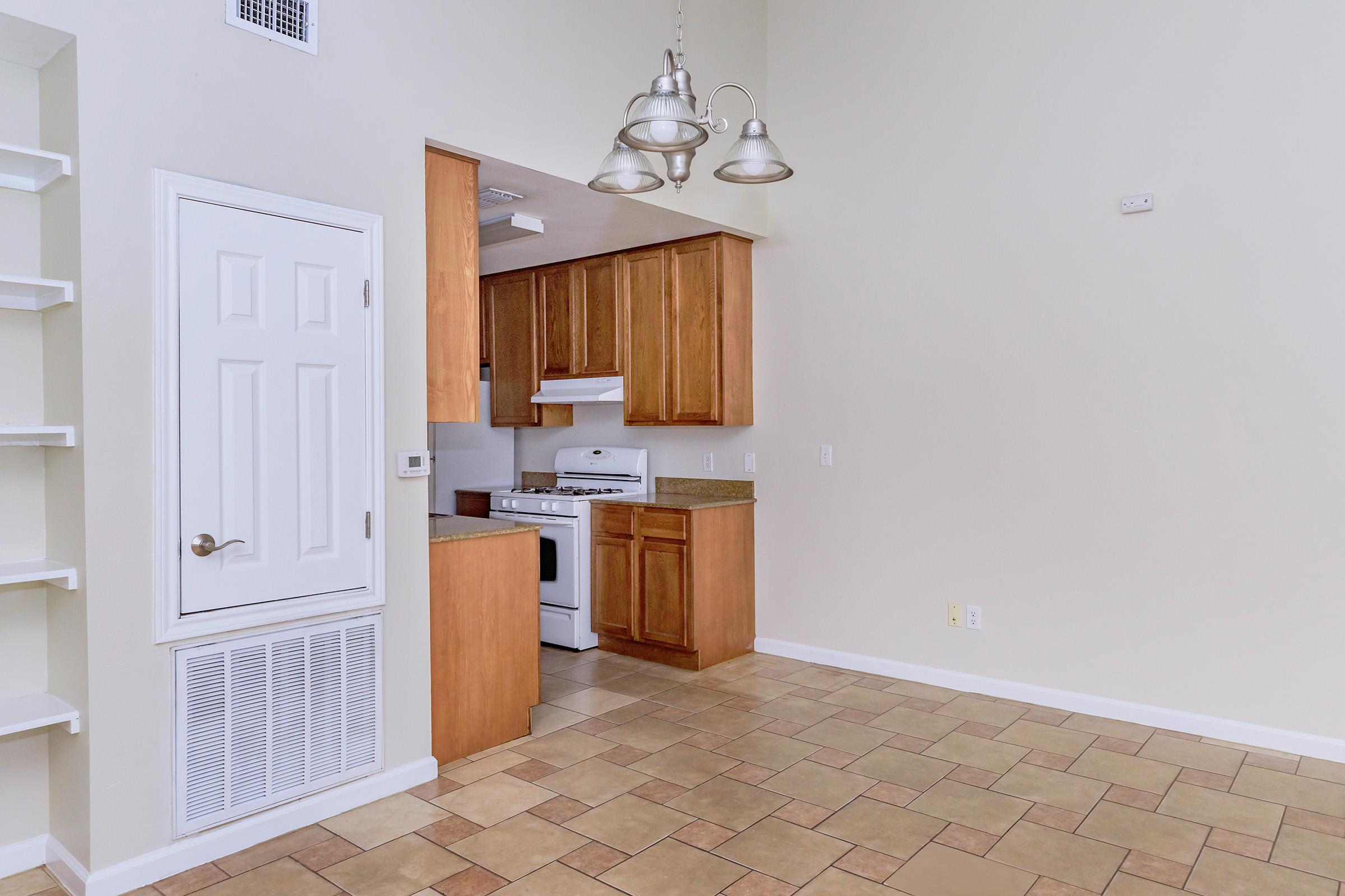 a kitchen with wooden cabinets