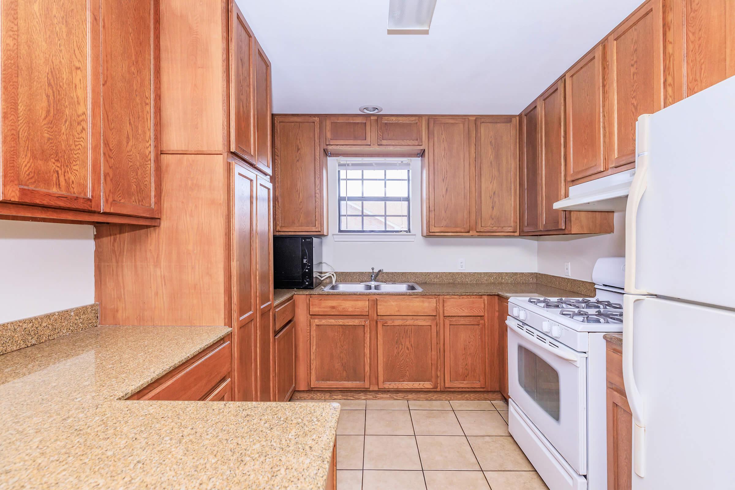 a kitchen with a refrigerator stove and microwave