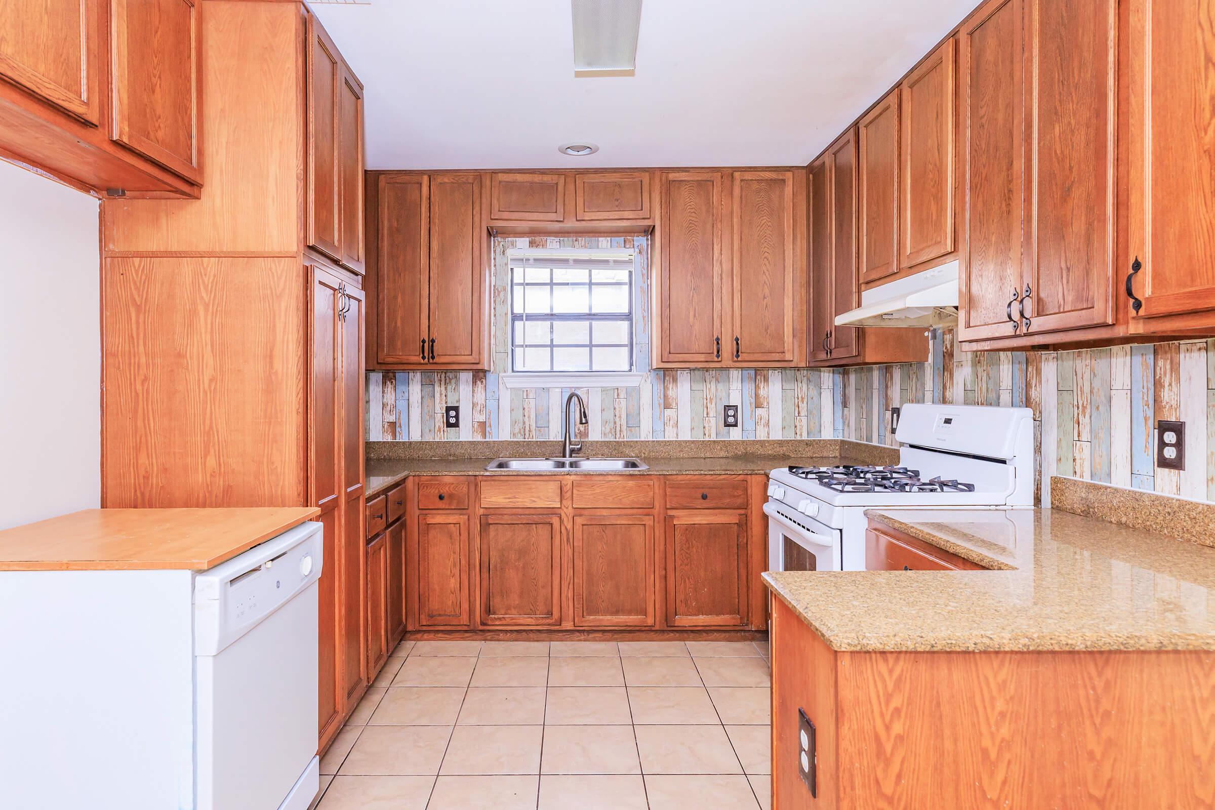 a kitchen with wooden cabinets