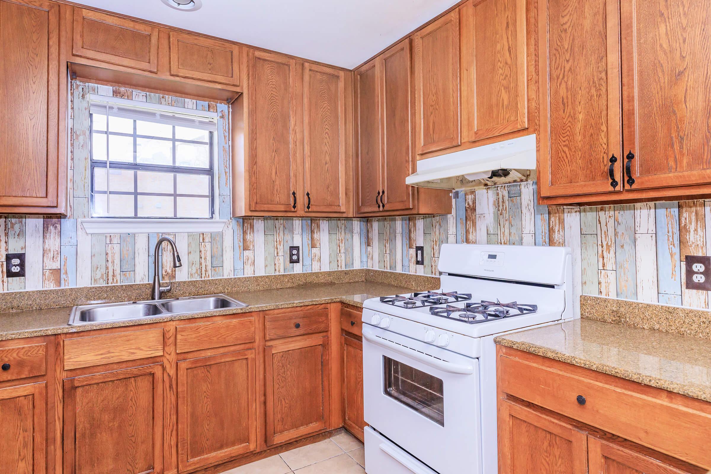 a kitchen with stainless steel appliances and wooden cabinets