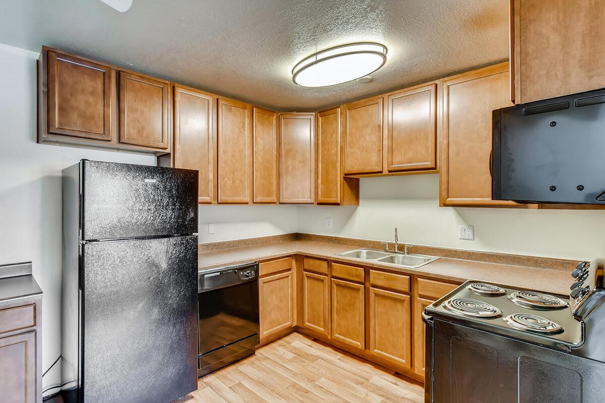 a kitchen with stainless steel appliances and wooden cabinets