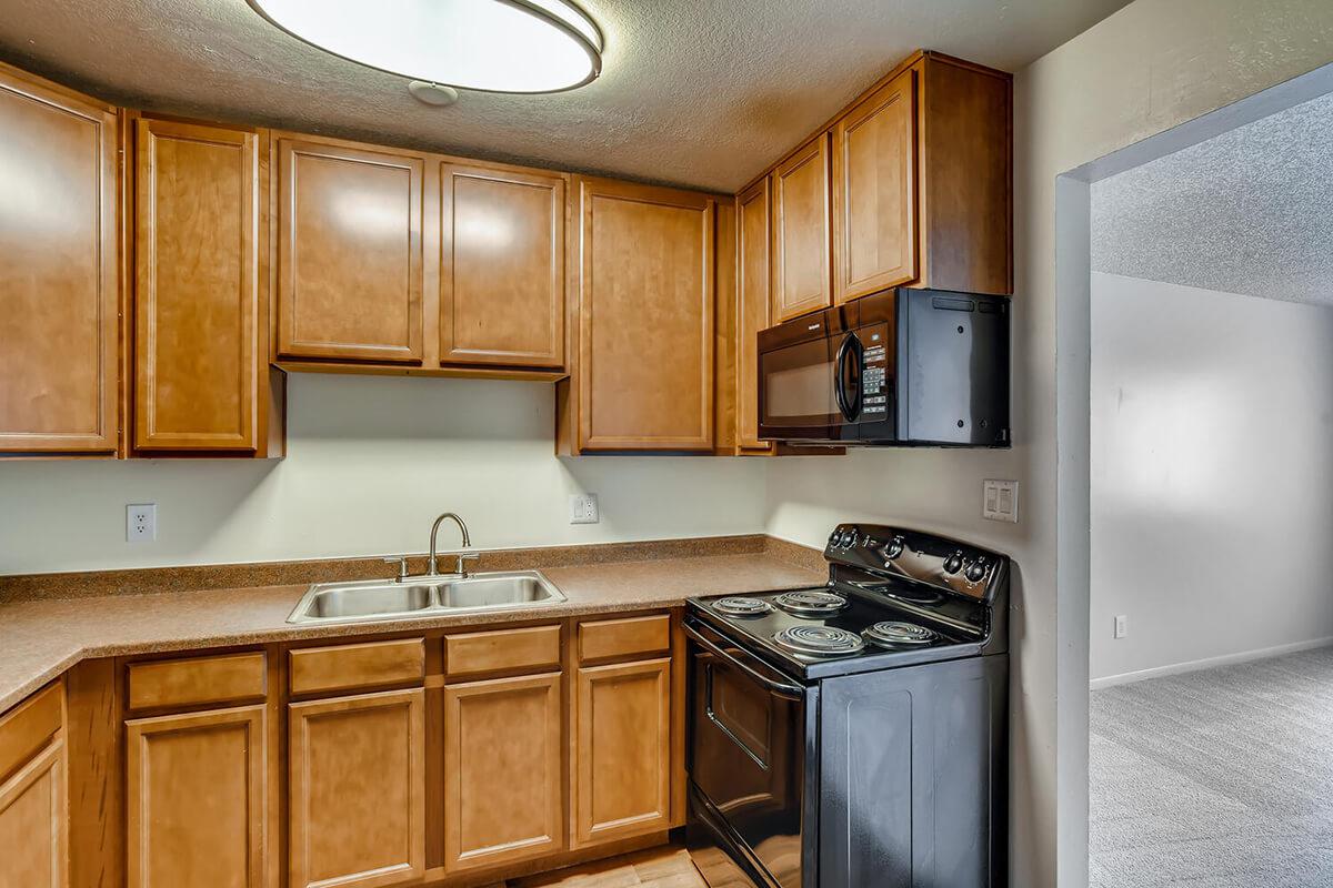 a kitchen with stainless steel appliances and wooden cabinets