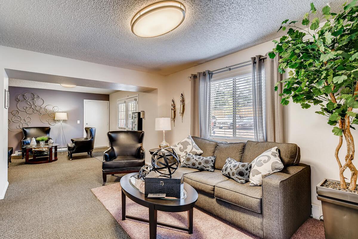 a living room filled with furniture and a large window