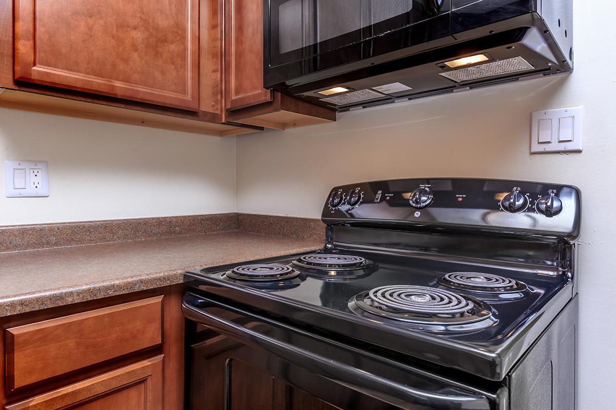 a stove top oven sitting inside of a kitchen