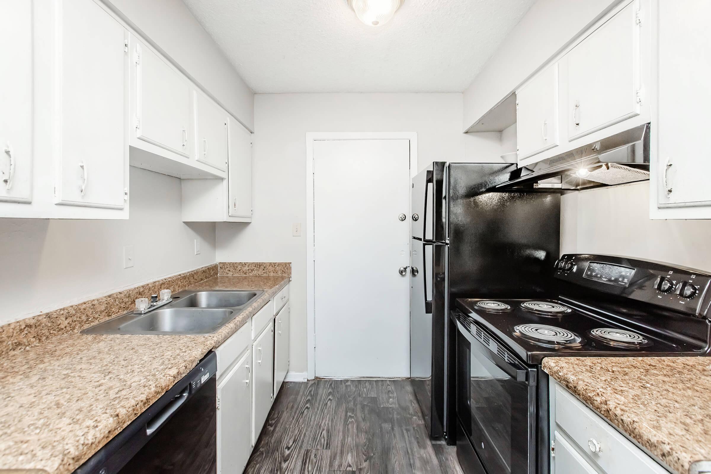 a kitchen with a stove and a sink