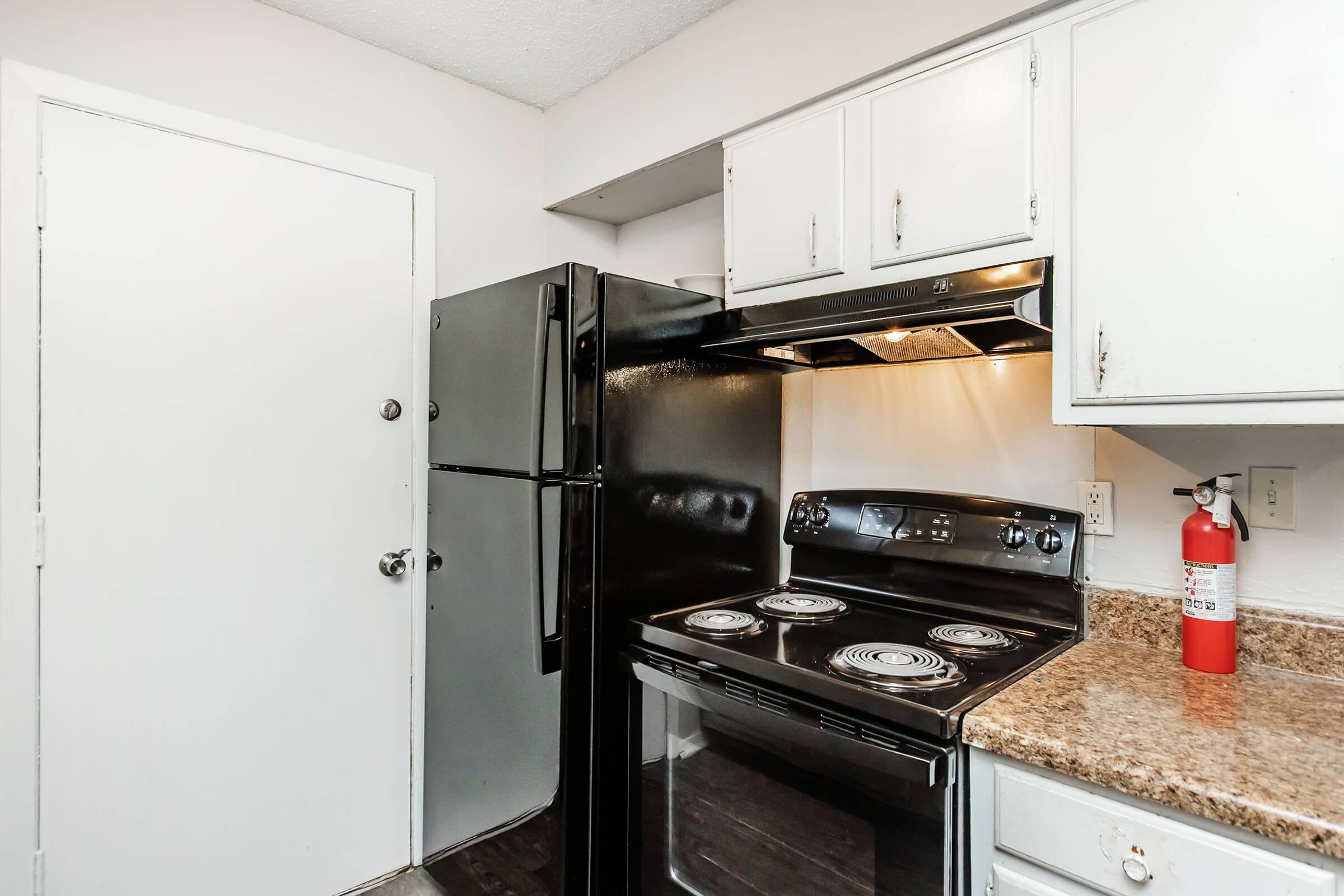 a stove top oven sitting inside of a kitchen