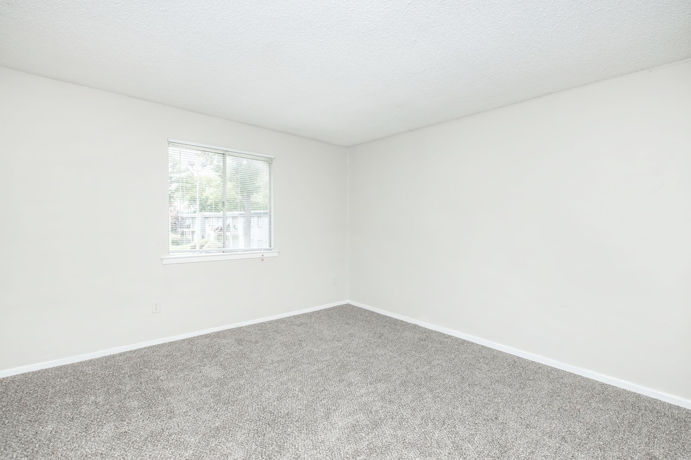 a bedroom with a large window