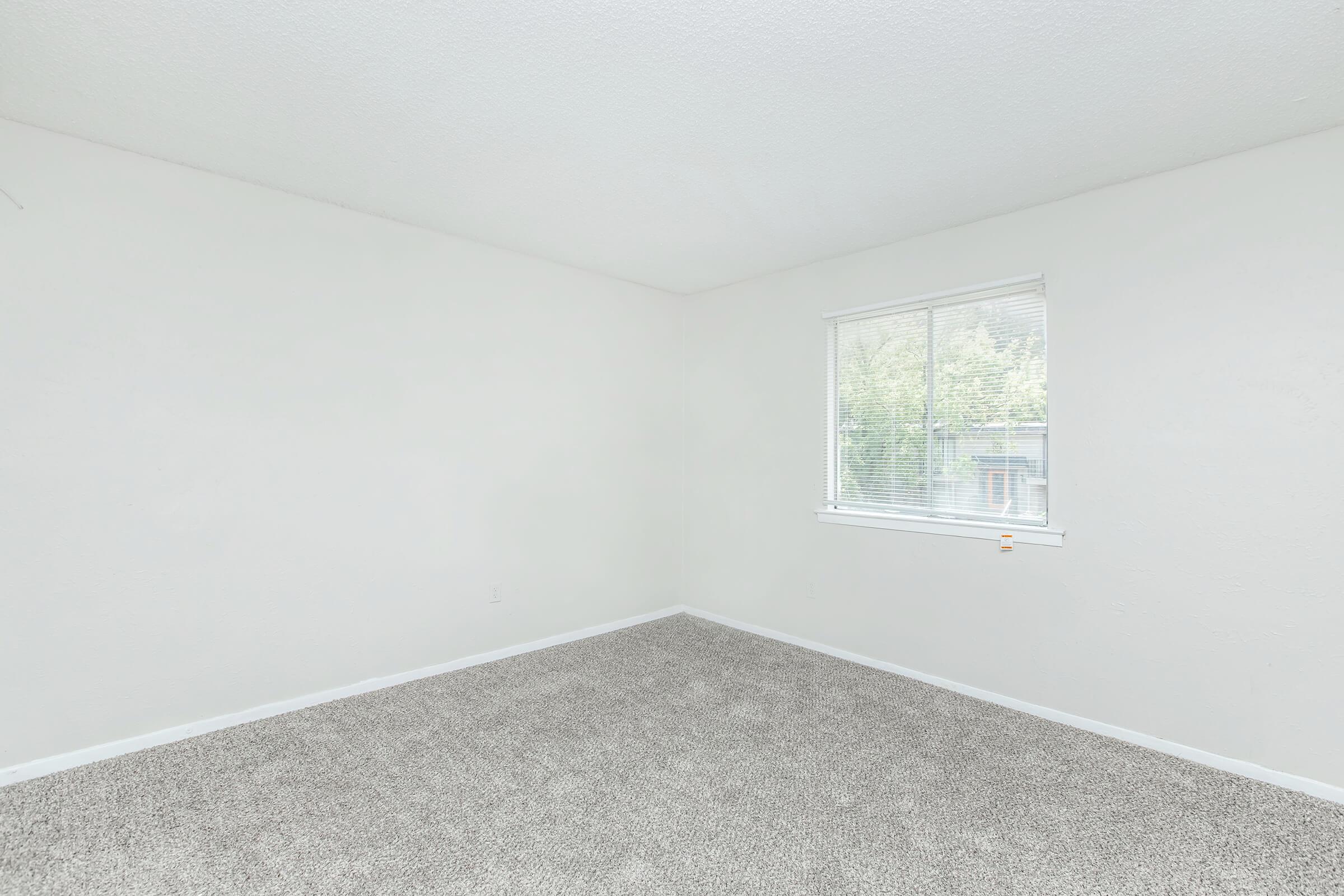 a bedroom with a large window