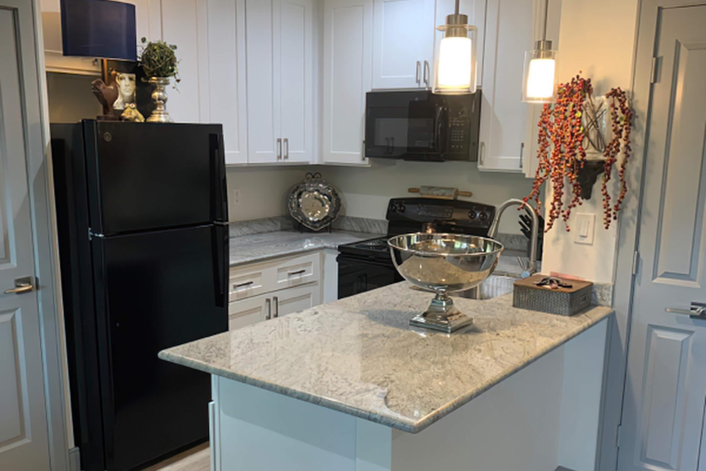 a kitchen with a sink and a mirror