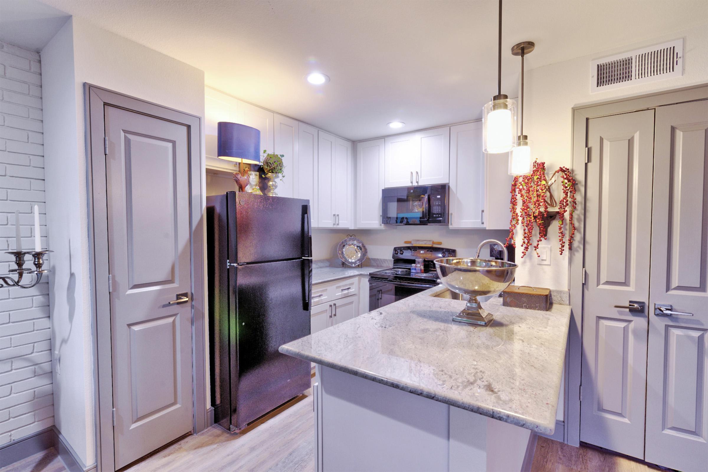 a kitchen with a stove sink and refrigerator